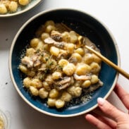 Mushroom gnocchi in a bowl with a fork.