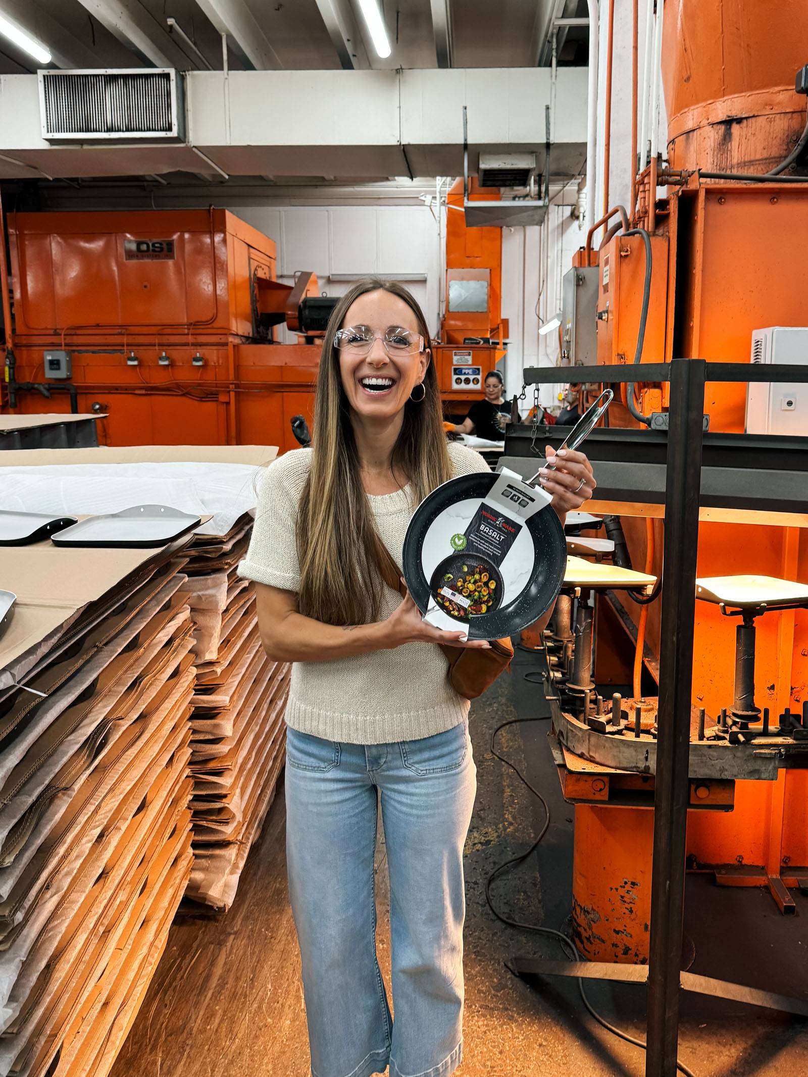 Lindsay holding a Basalt skillet in the Nordic Ware factory.