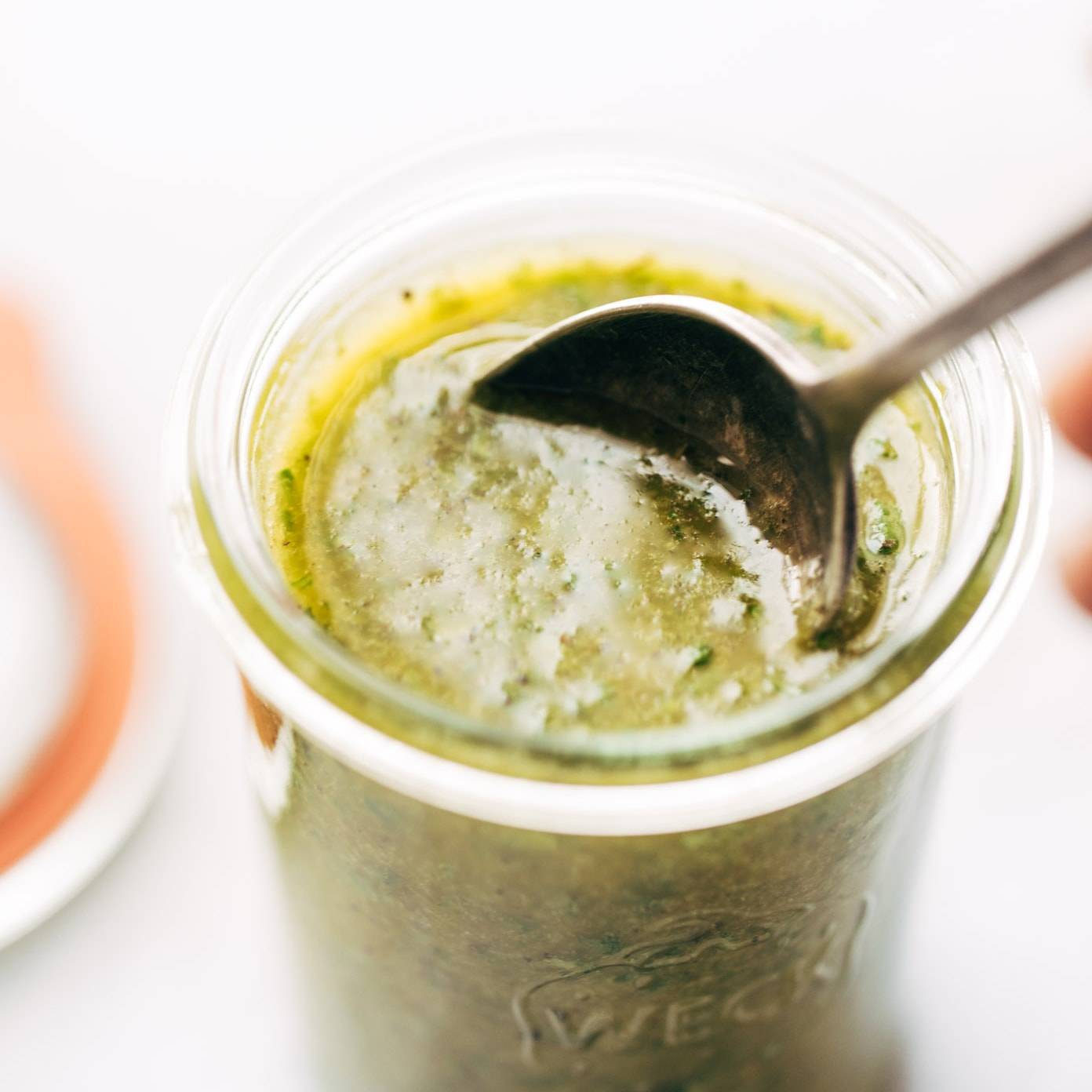 Sunshine Sauce in jar with spoon.