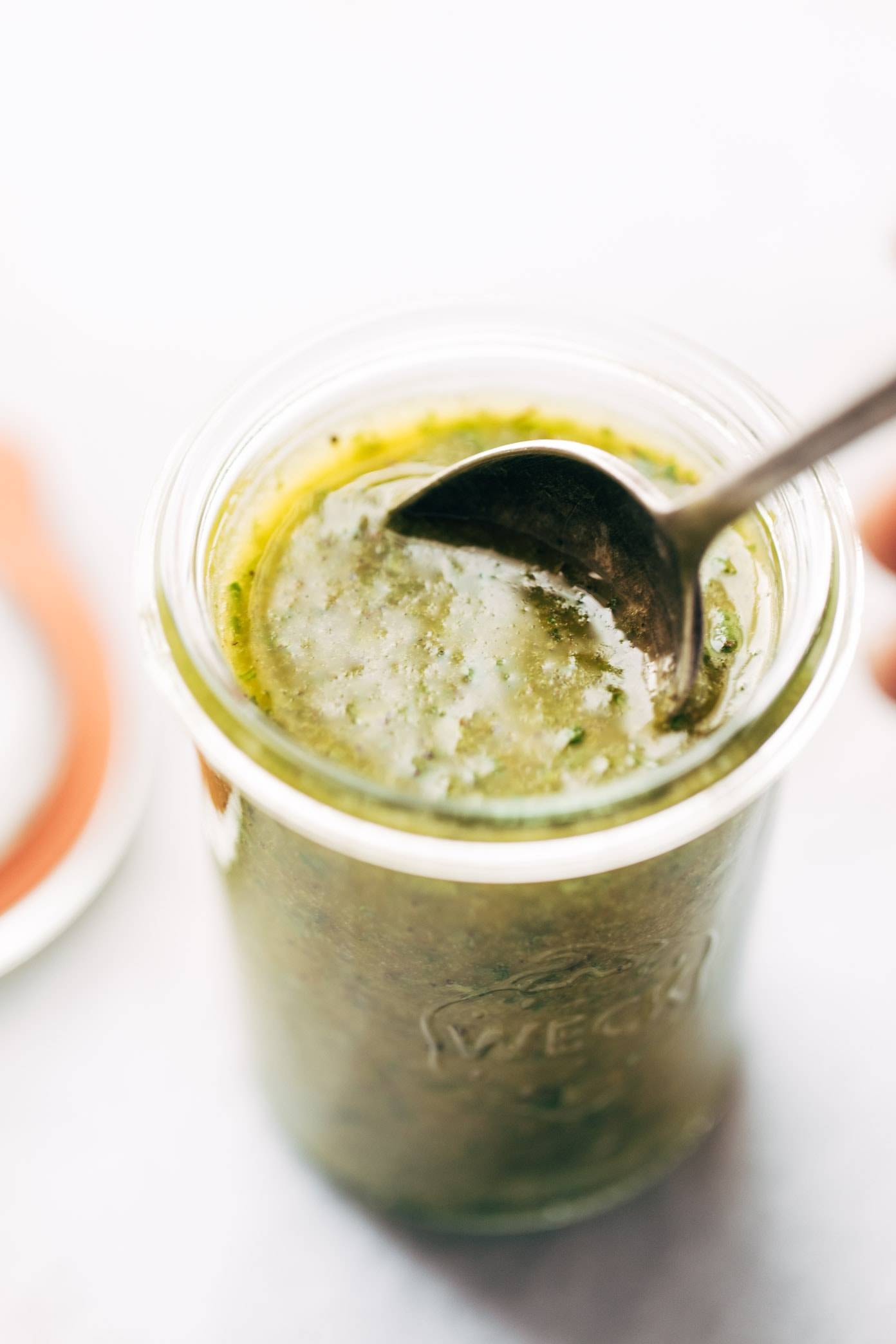 Sunshine sauce in jar with a spoon.