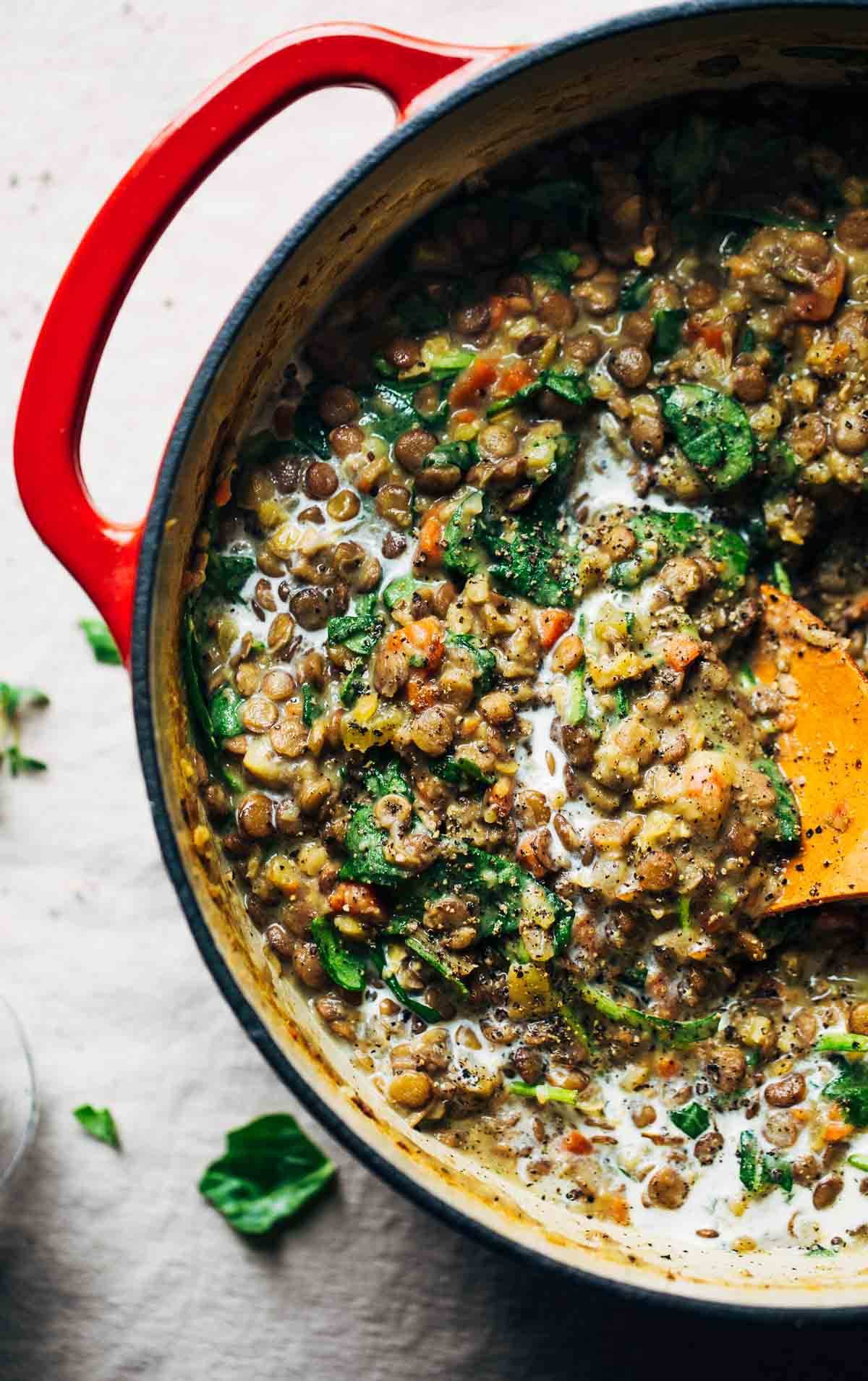 One-Pot Creamy Spinach Lentils in a red dutch oven.