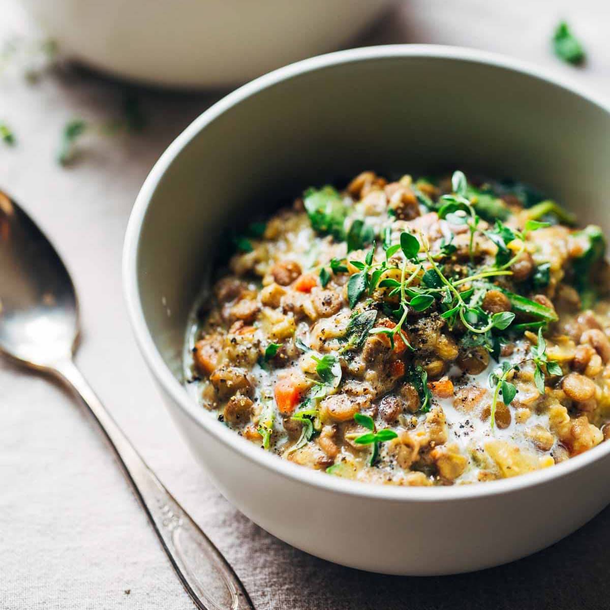 One-Pot Creamy Spinach Lentils in a bowl with spoon.
