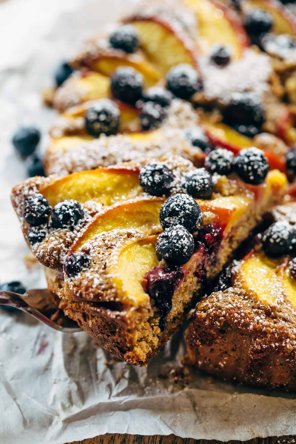 Fresh Blueberry Peach Cake with blueberries and coconut sugar spread over it.