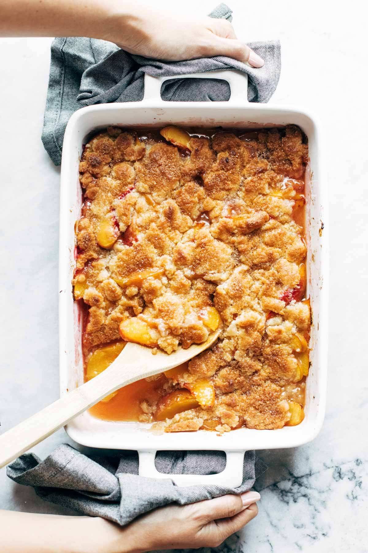 Peach cobbler baked in a pan.