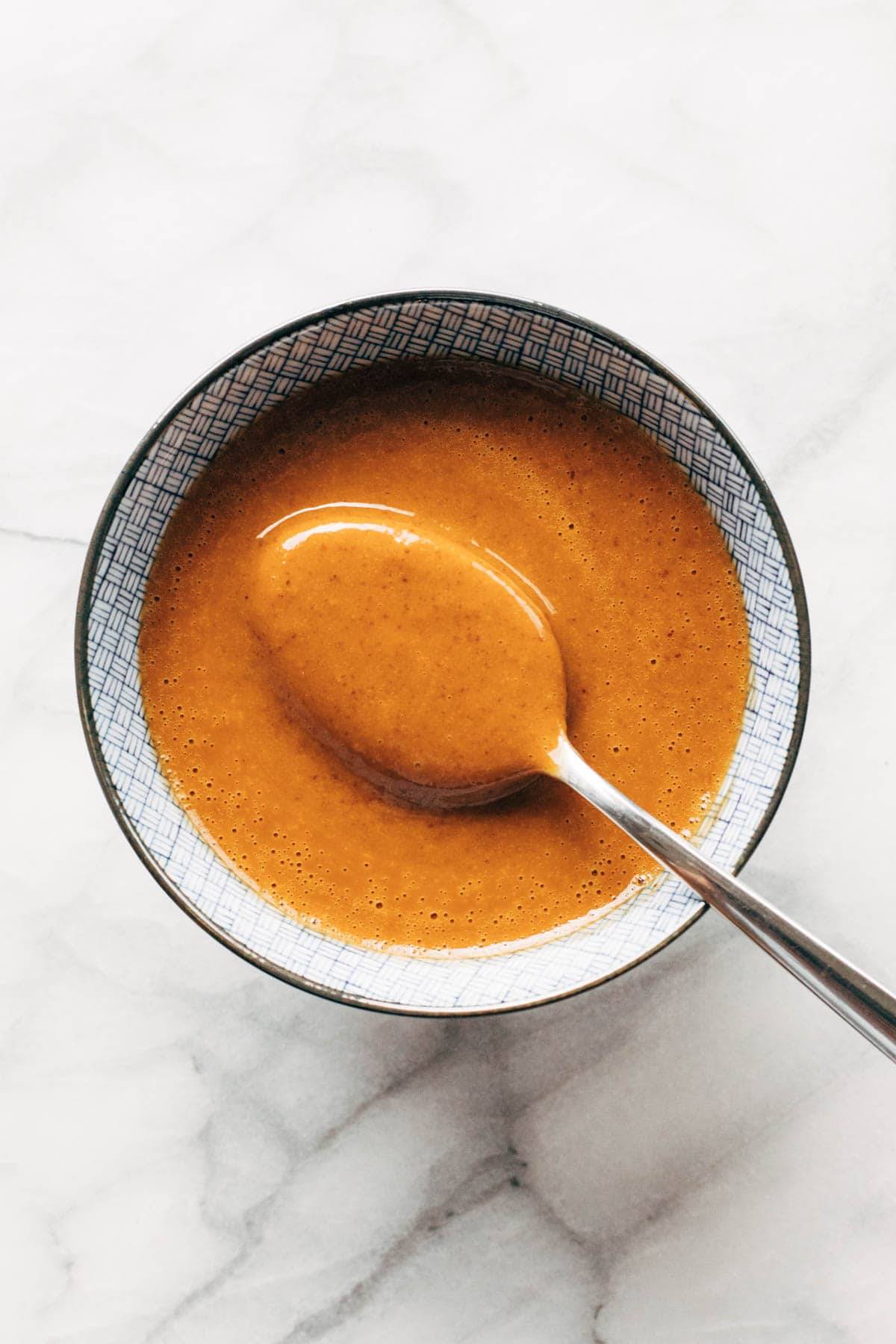 Peanut sauce in a bowl with spoon.