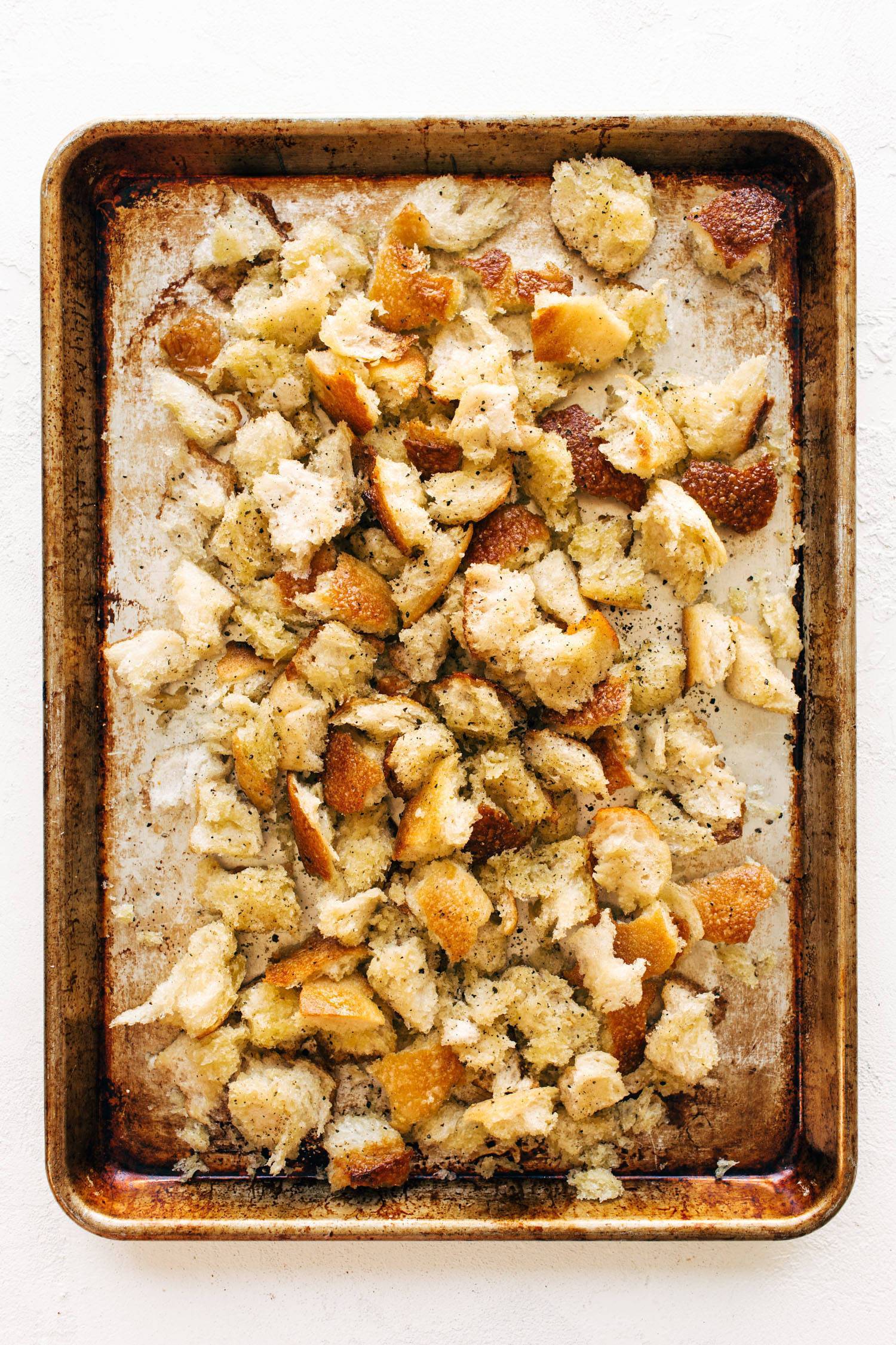 Peppery torn croutons on a sheet pan.