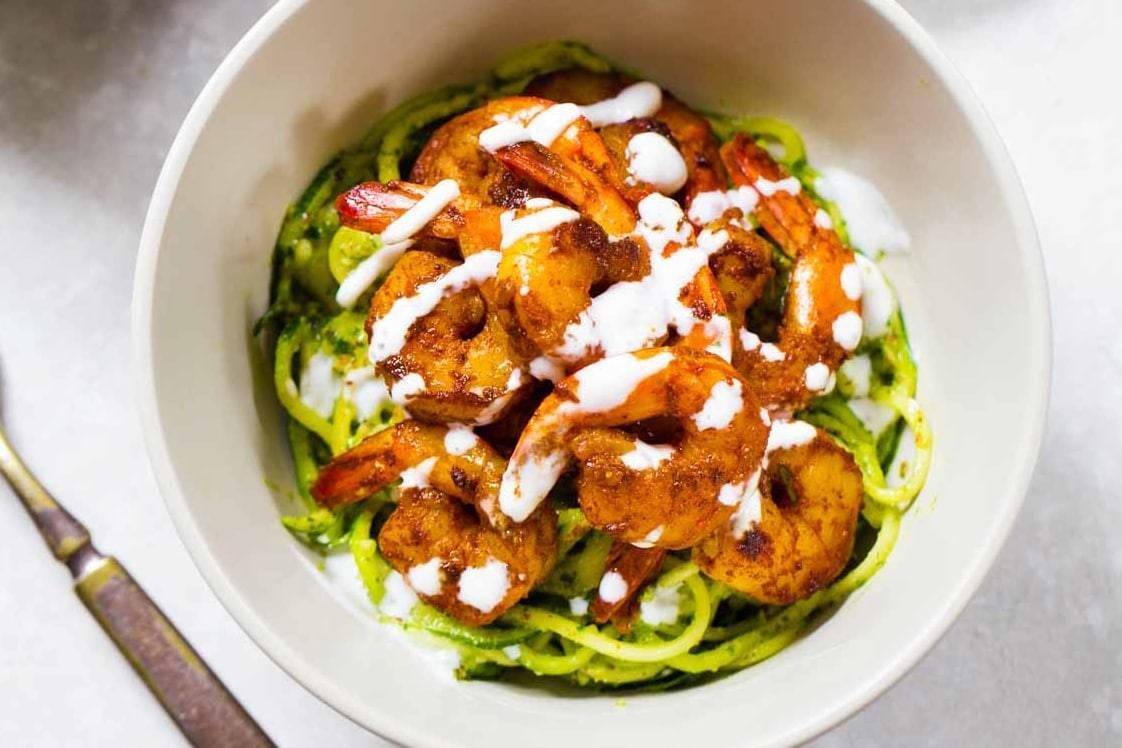 Pesto Noodles with Spicy Shrimp in a white bowl.