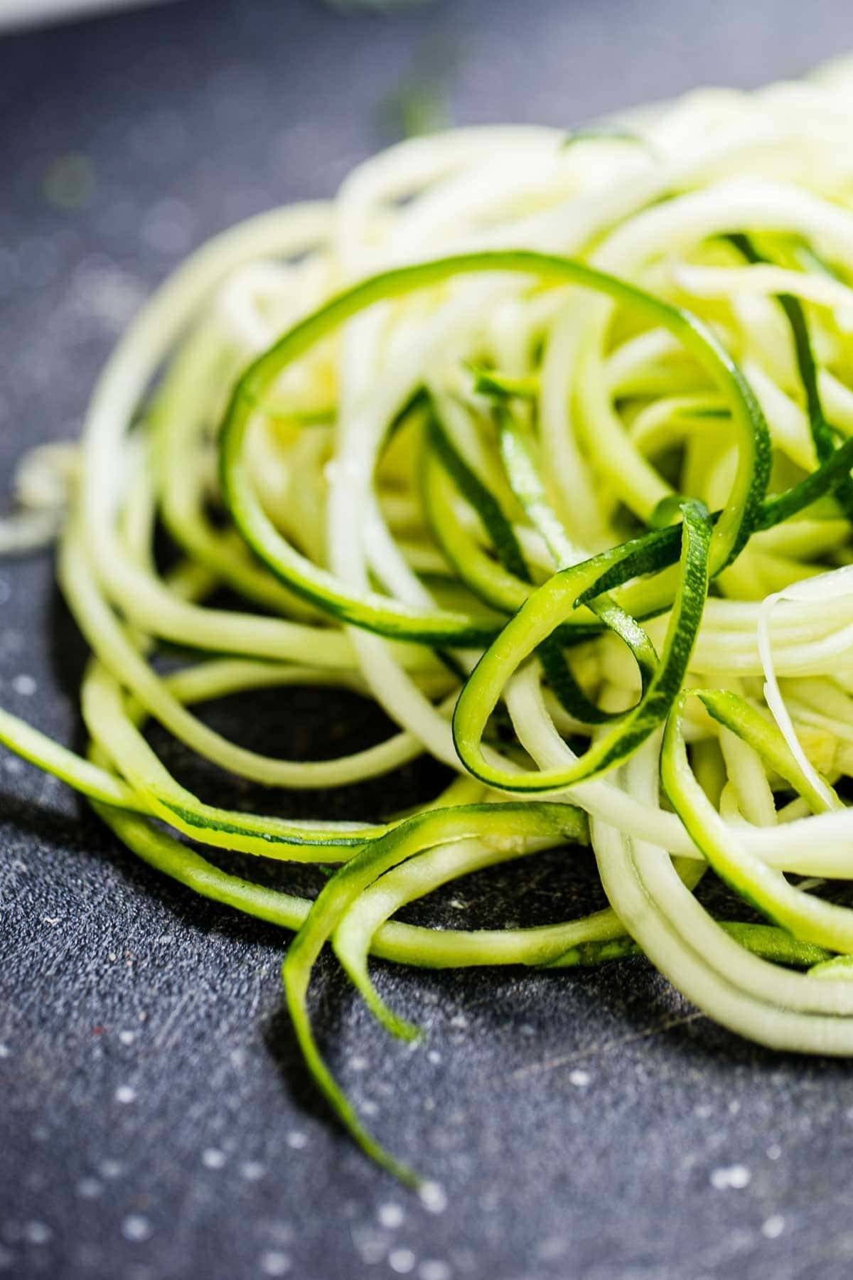 Zoodles on a cutting board.
