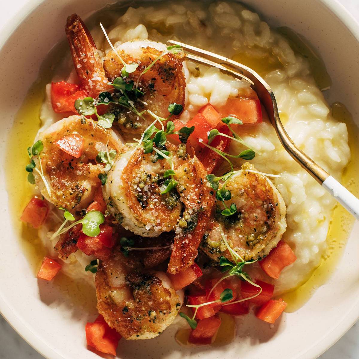 Pesto shrimp and risotto in a bowl with a fork square