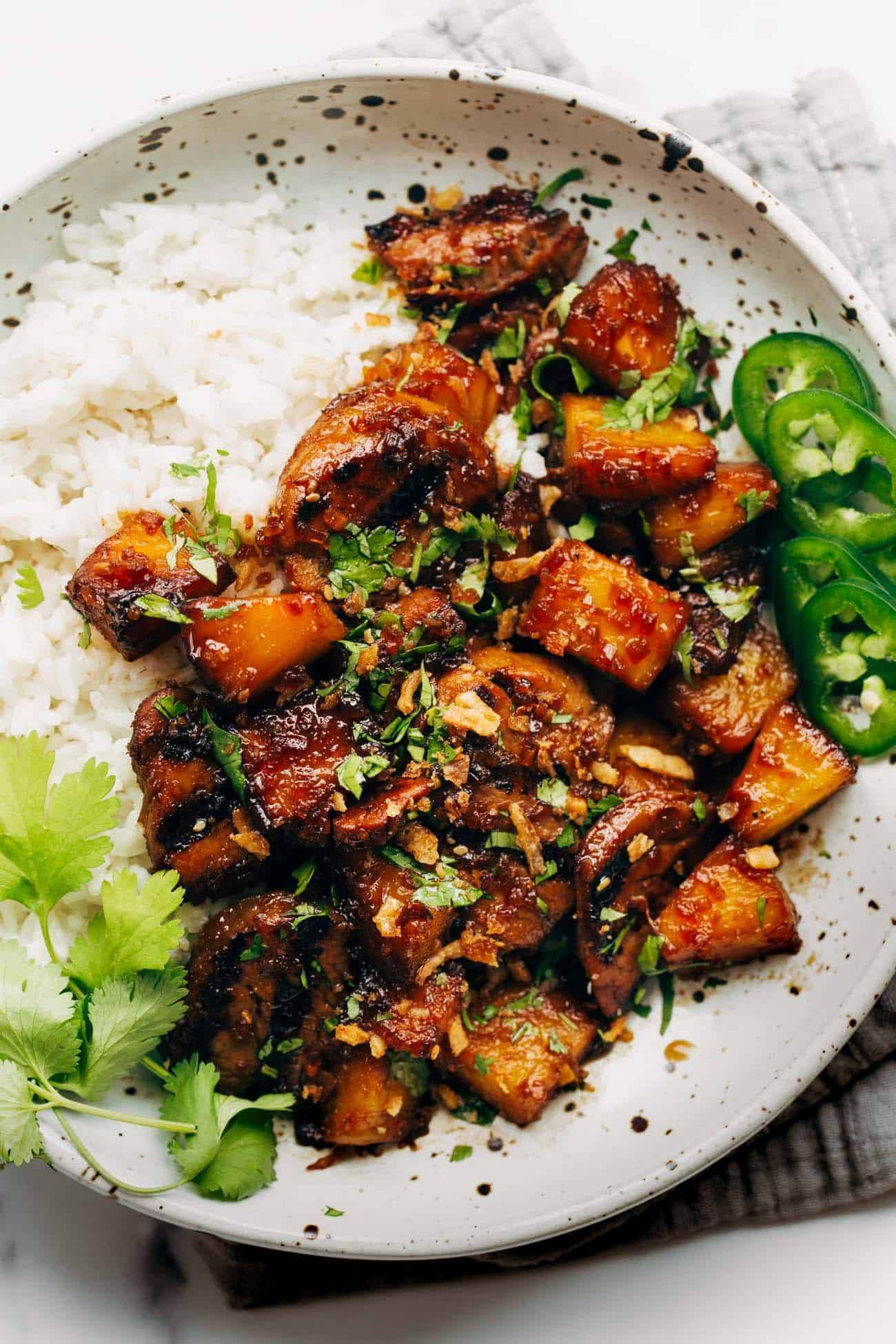 Pineapple pork with coconut rice on a plate