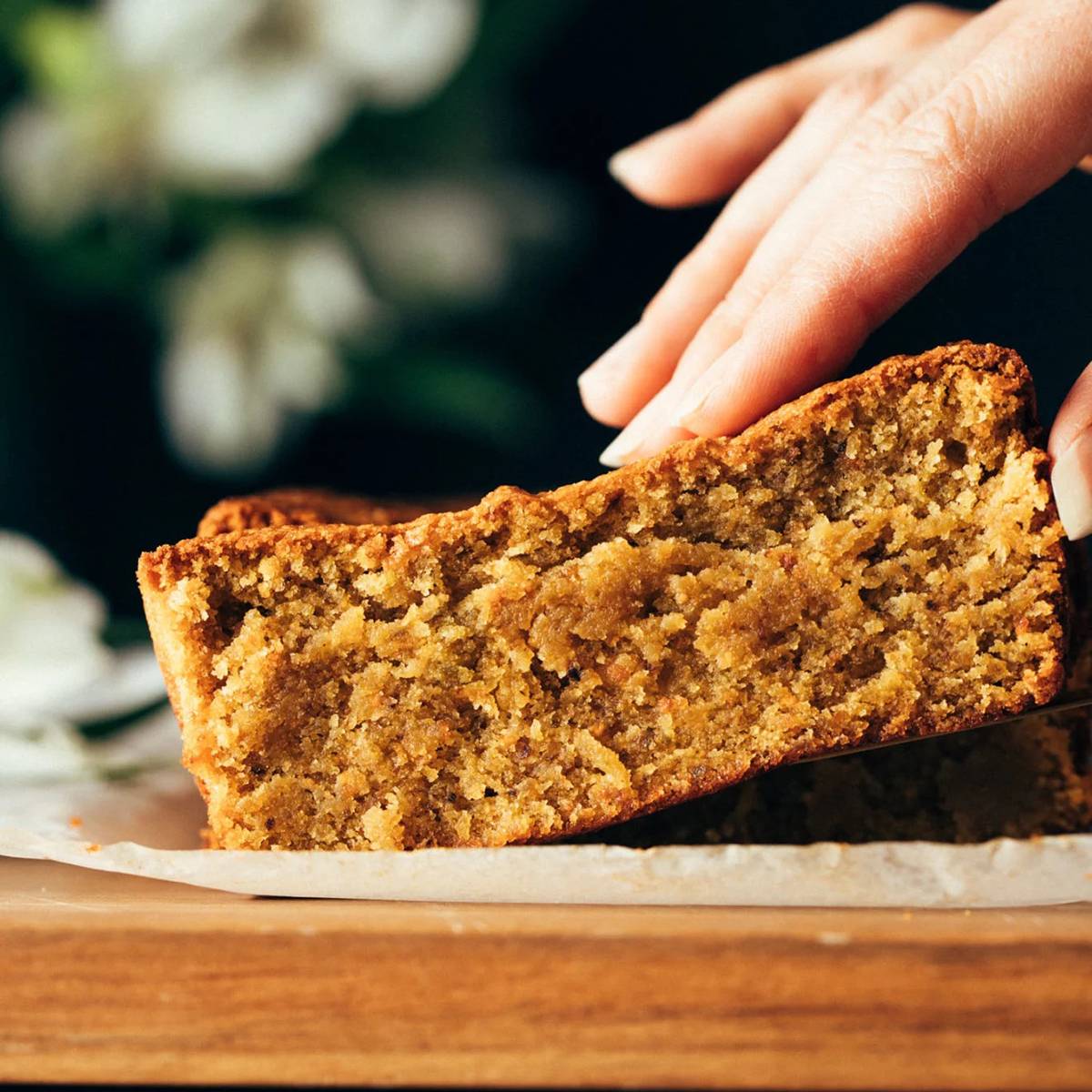 Pistachio loaf being held by white hand square