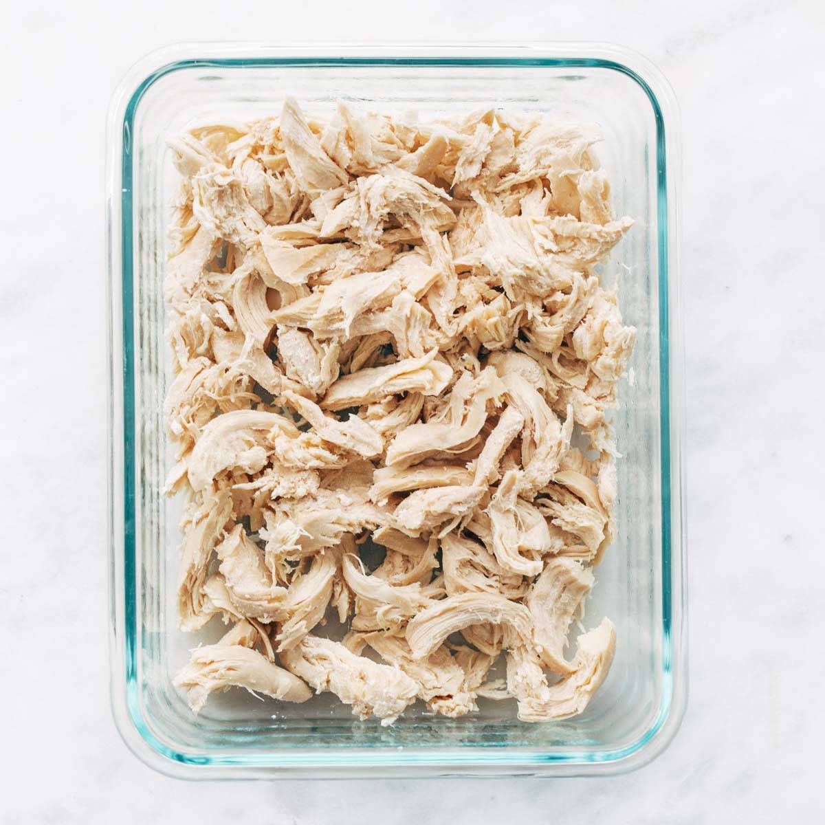 Shredded chicken in container.