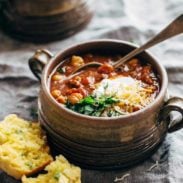 Spicy Posole in soup mug with cornbread.