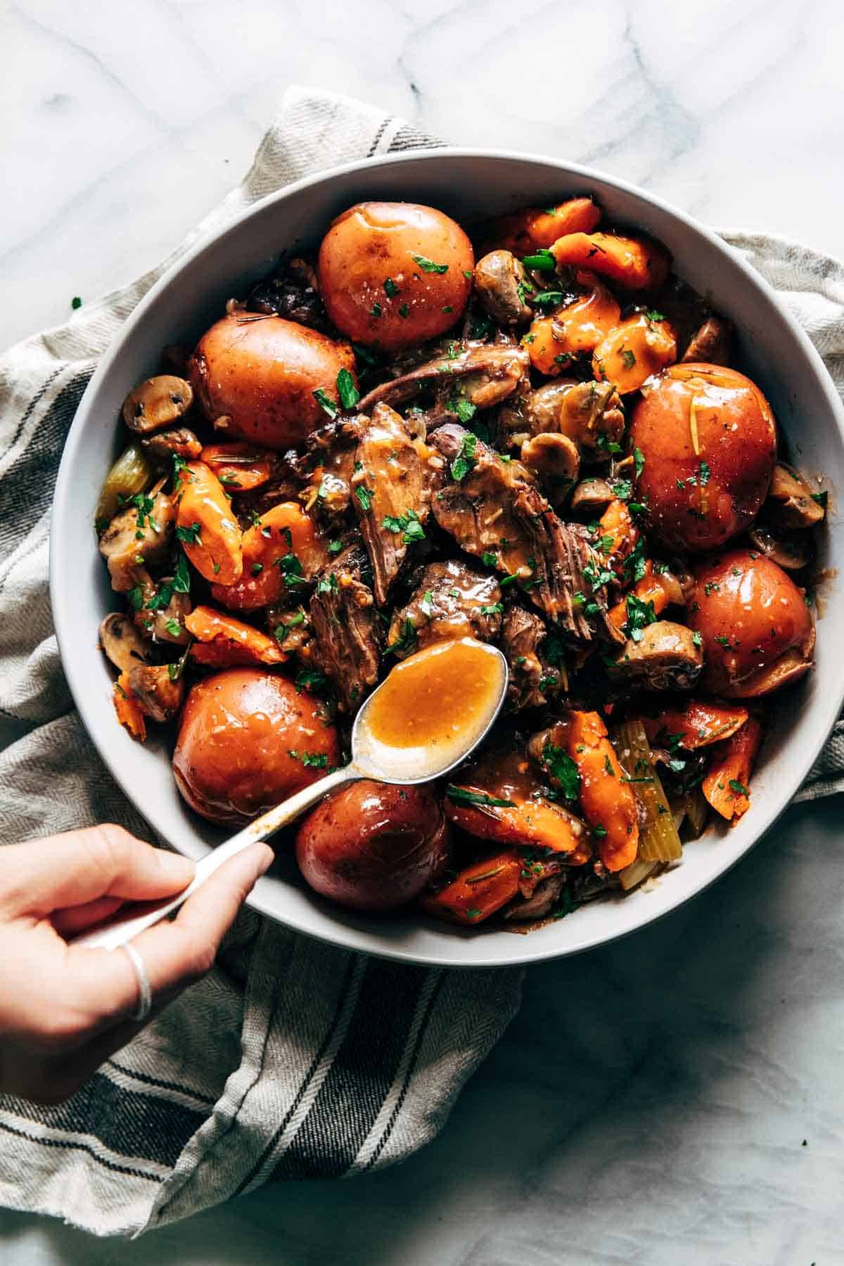 Instant Pot Pot Roast in a serving bowl with gravy on top.