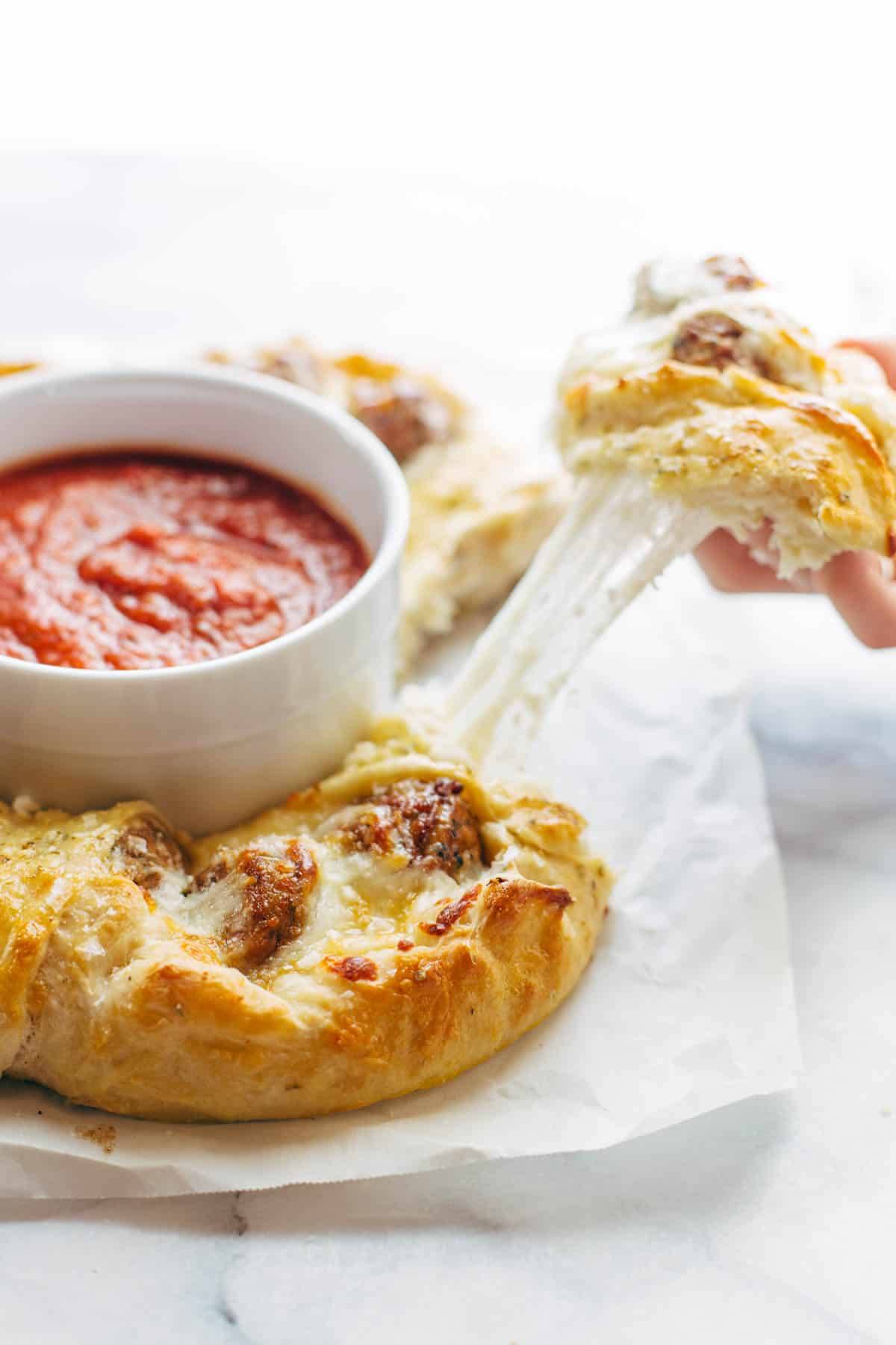 Cheesy Meatball Pull-Apart Pizza Ring with a dish of marinara sauce