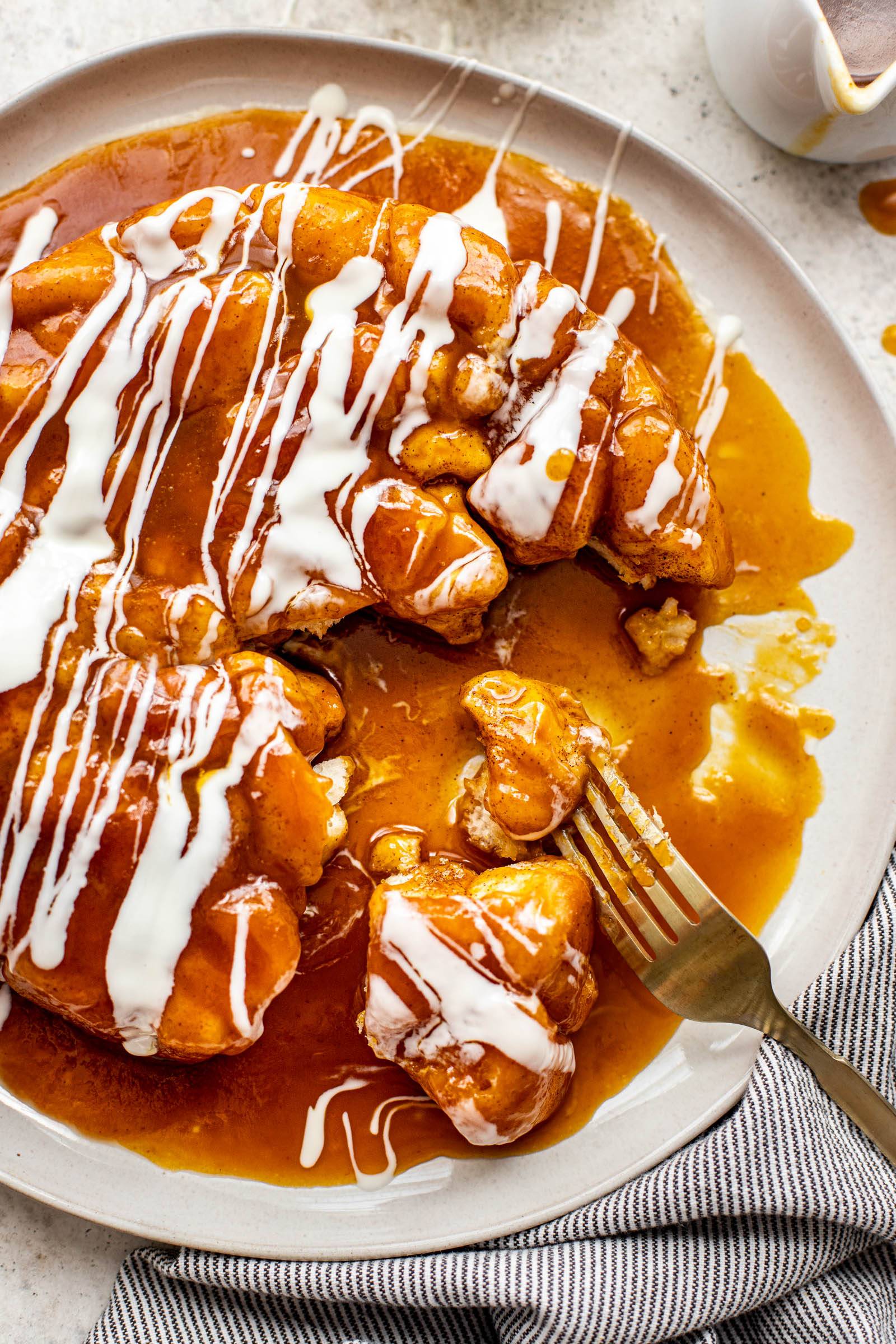 White chocolate drizzled on top of pumpkin caramel monkey bread.