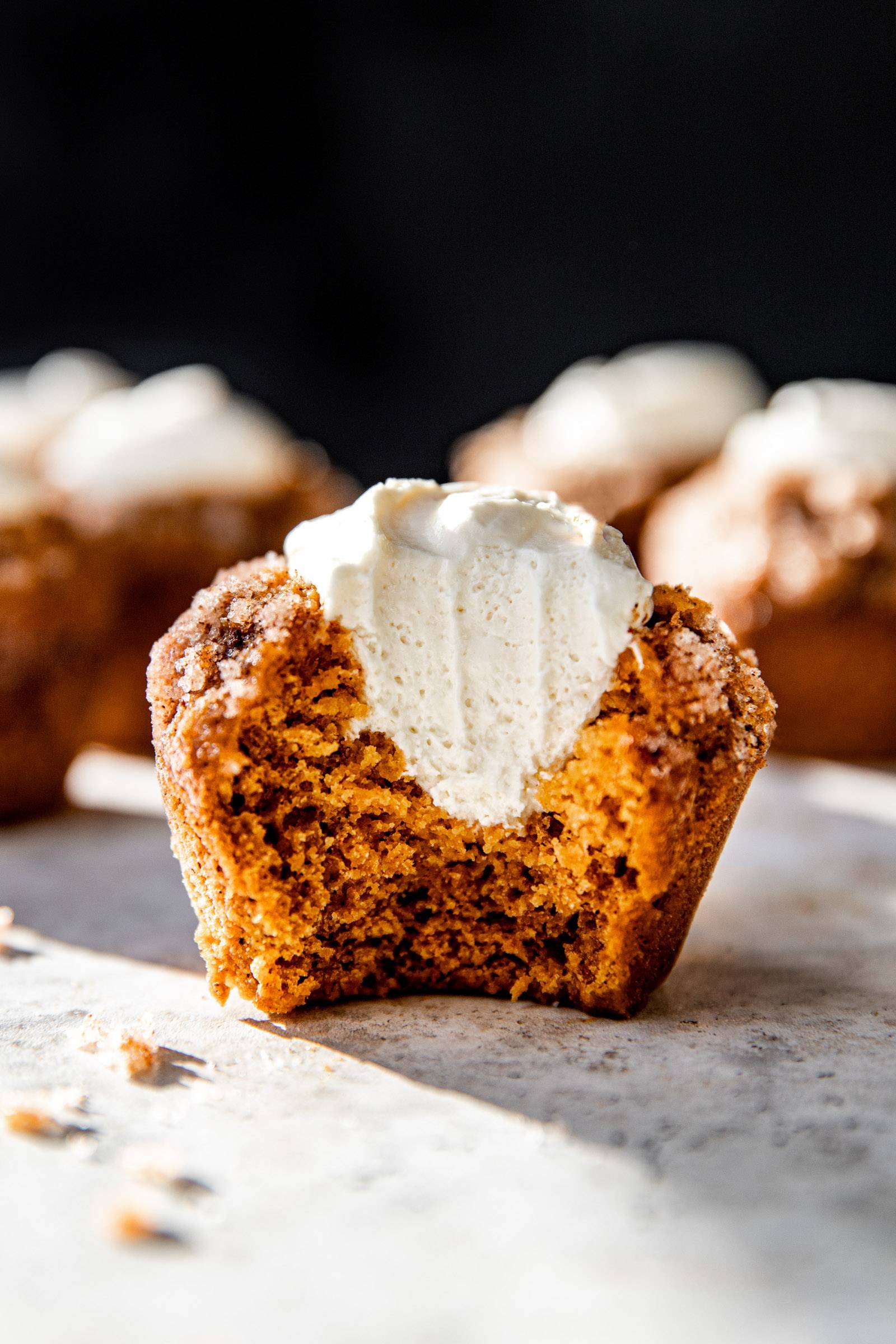 Bite shot of a pumpkin muffin filled with cream cheese.