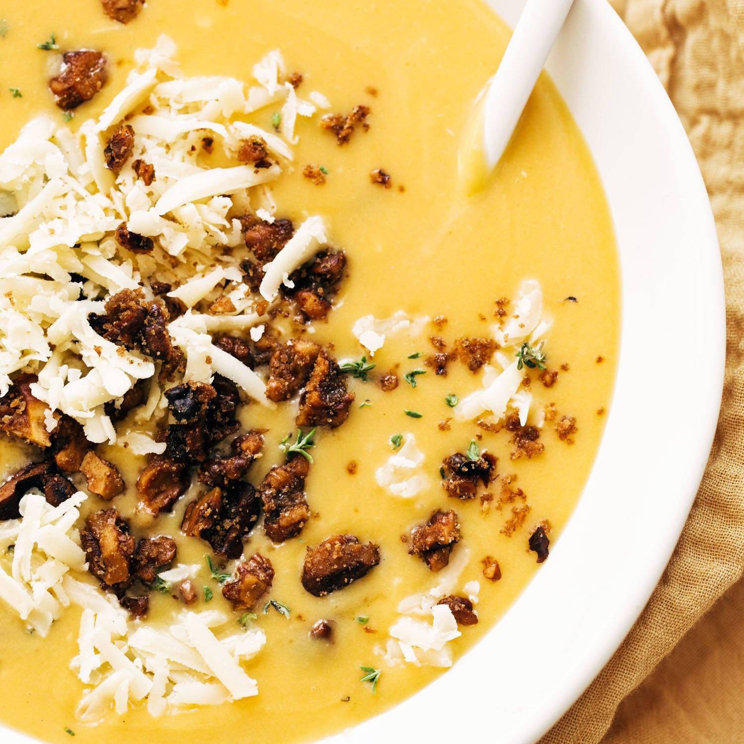 Pumpkin soup with walnut crispies in a bowl.