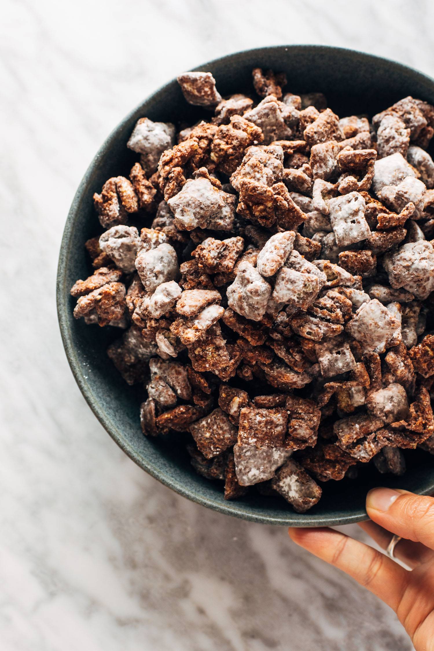Puppy chow piled in a bowl.