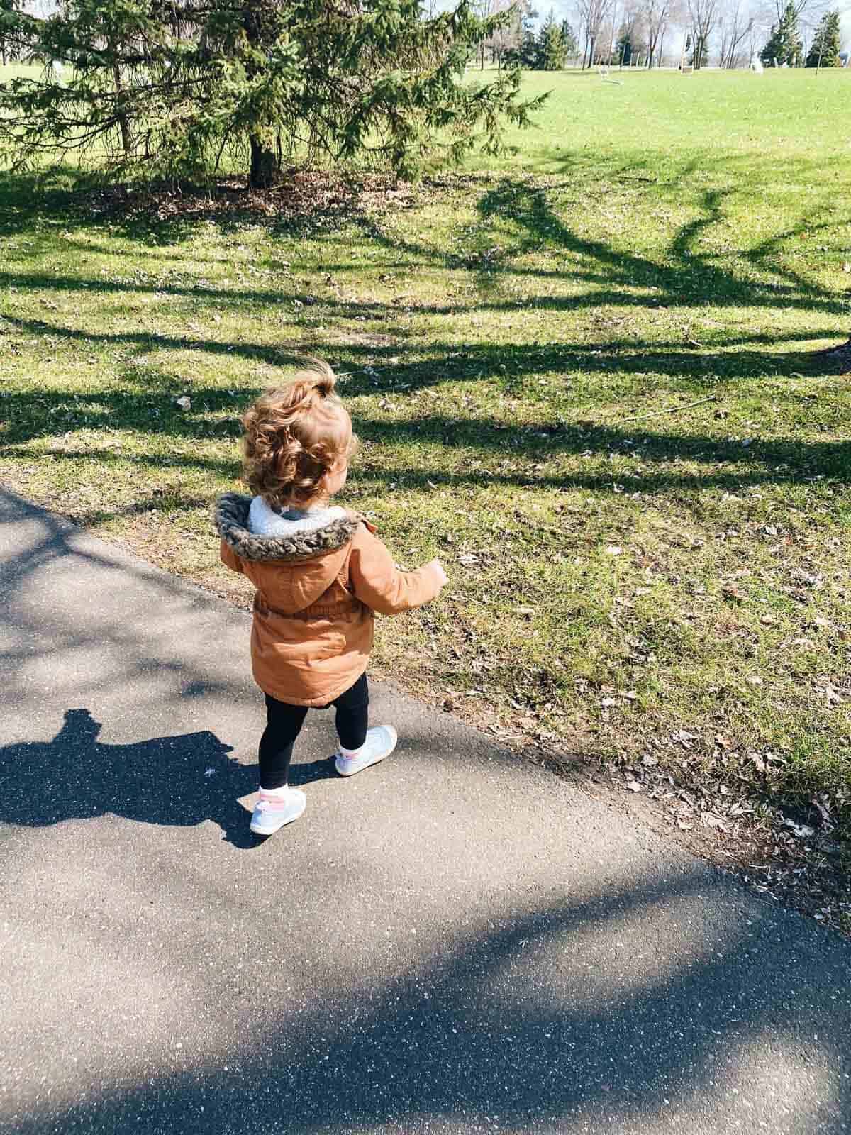 A child running towards some grass.