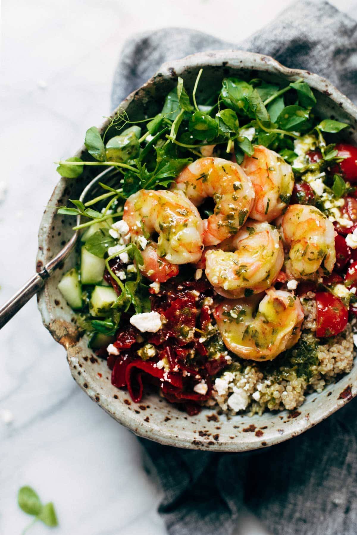 Summer Quinoa Salad with shrimp and dressing in a bowl.