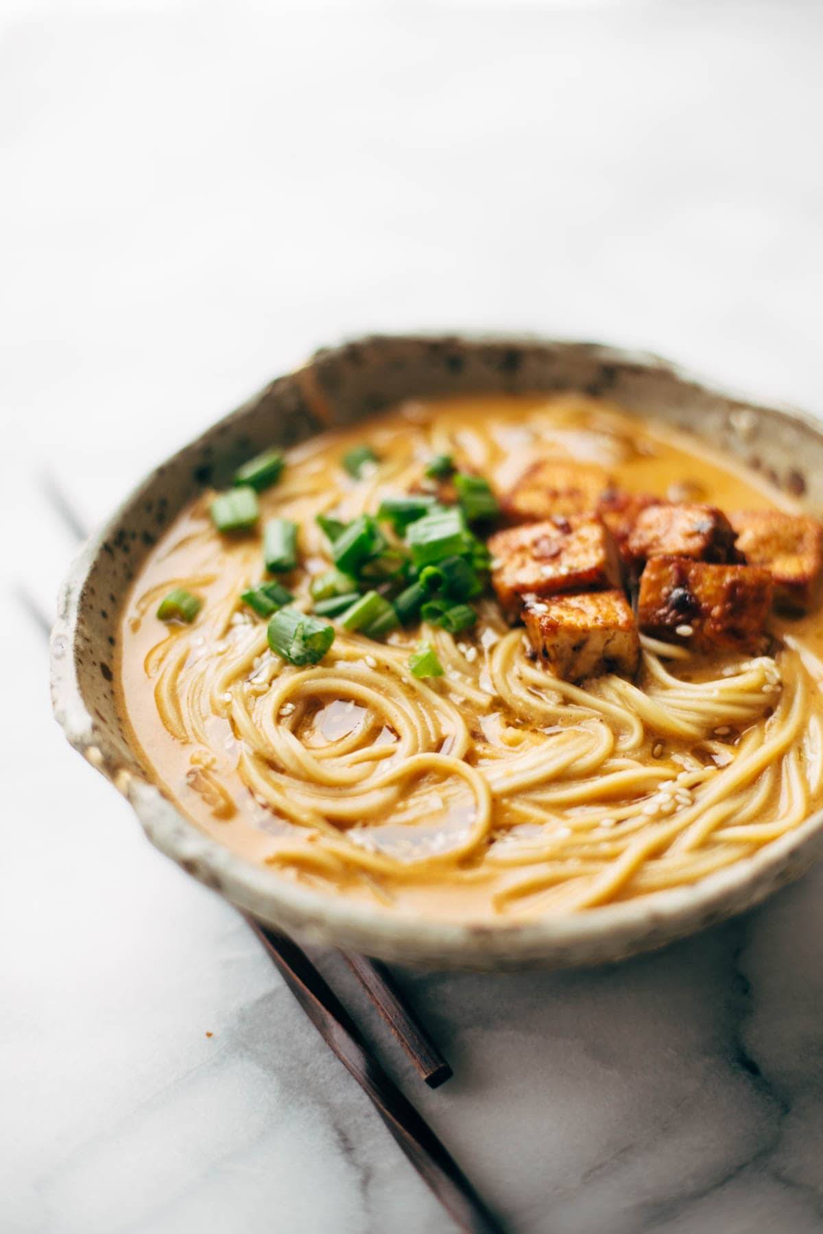 Homemade Spicy Ramen recipe with an easy spicy miso paste for the broth and dry ramen noodles that taste JUST like fresh! Vegetarian / vegan. | pinchofyum.com