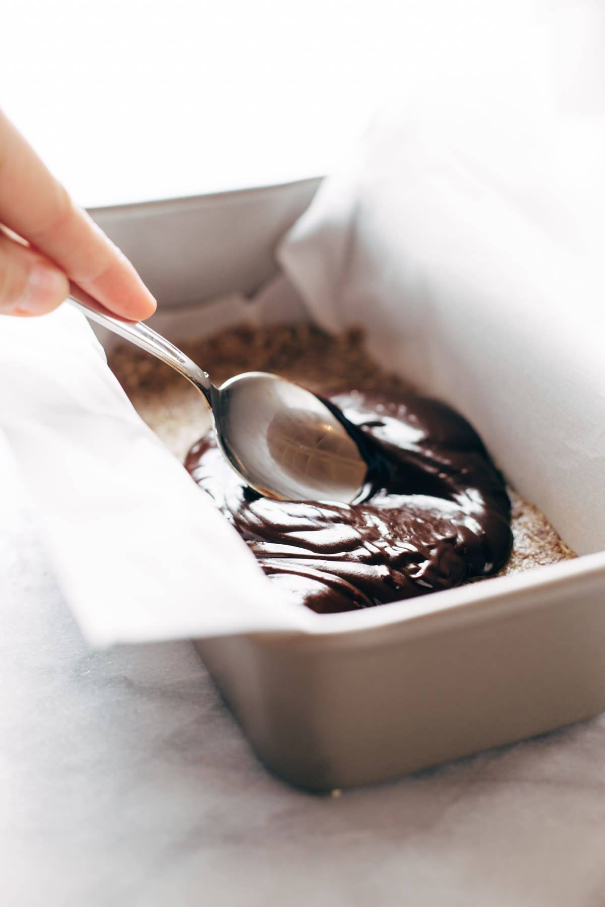 Raw Salted Chocolate Bars in a pan with a spoon.