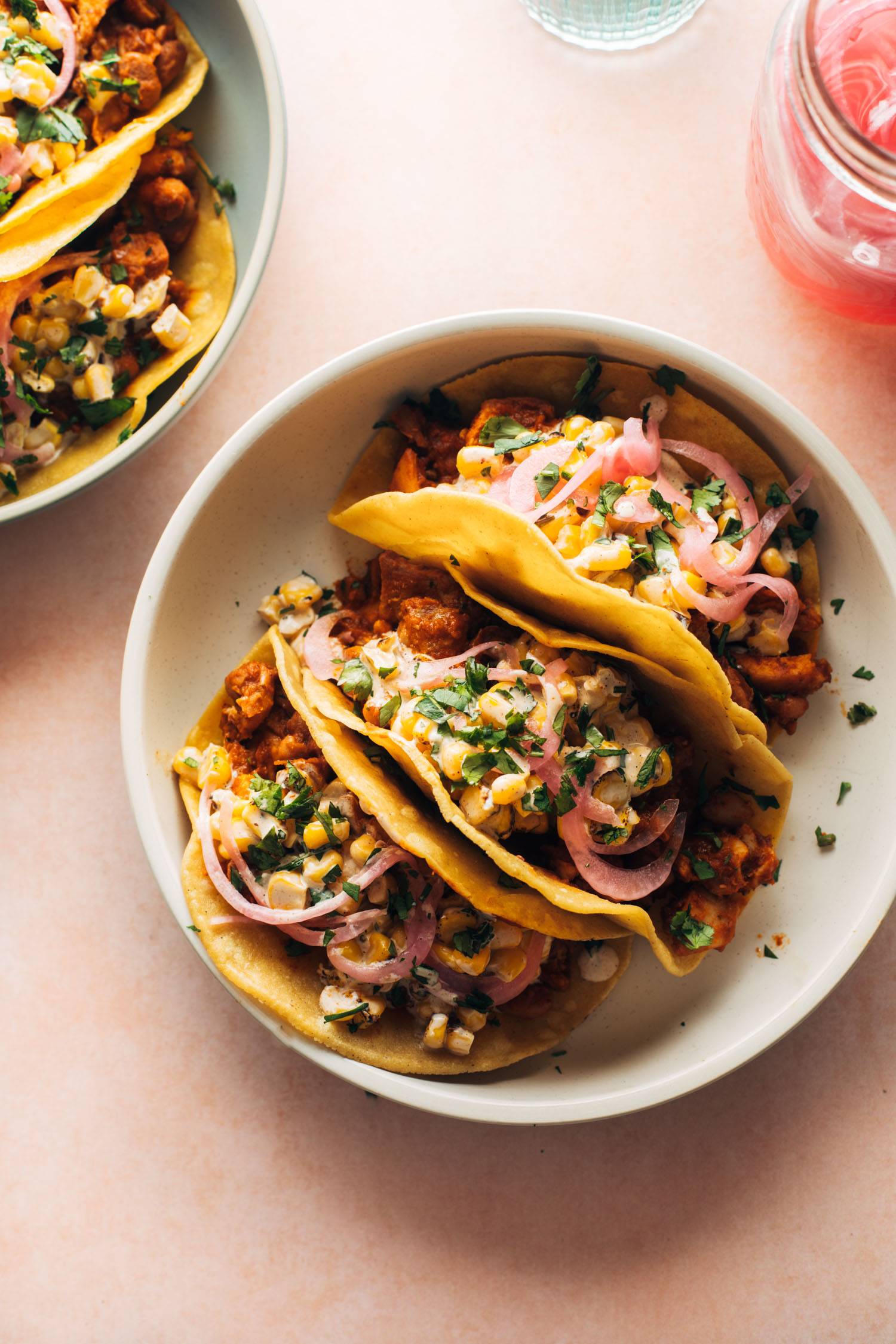Chicken tacos on a plate with creamy corn