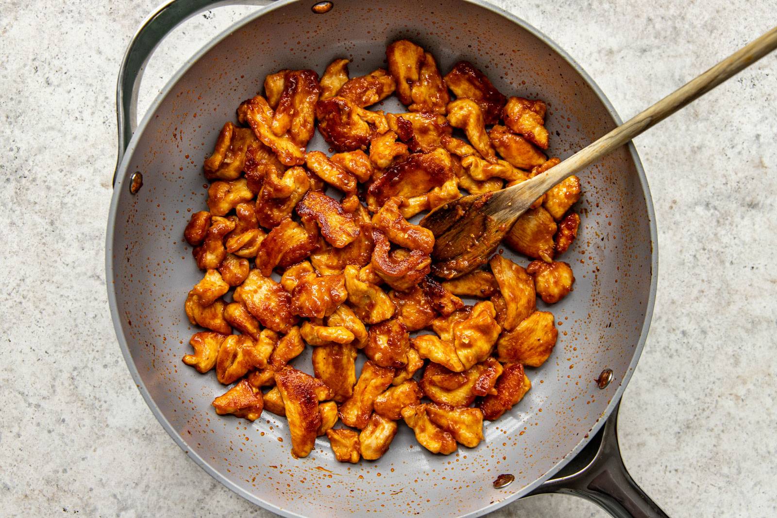 Caramelized chicken pieces in a pan