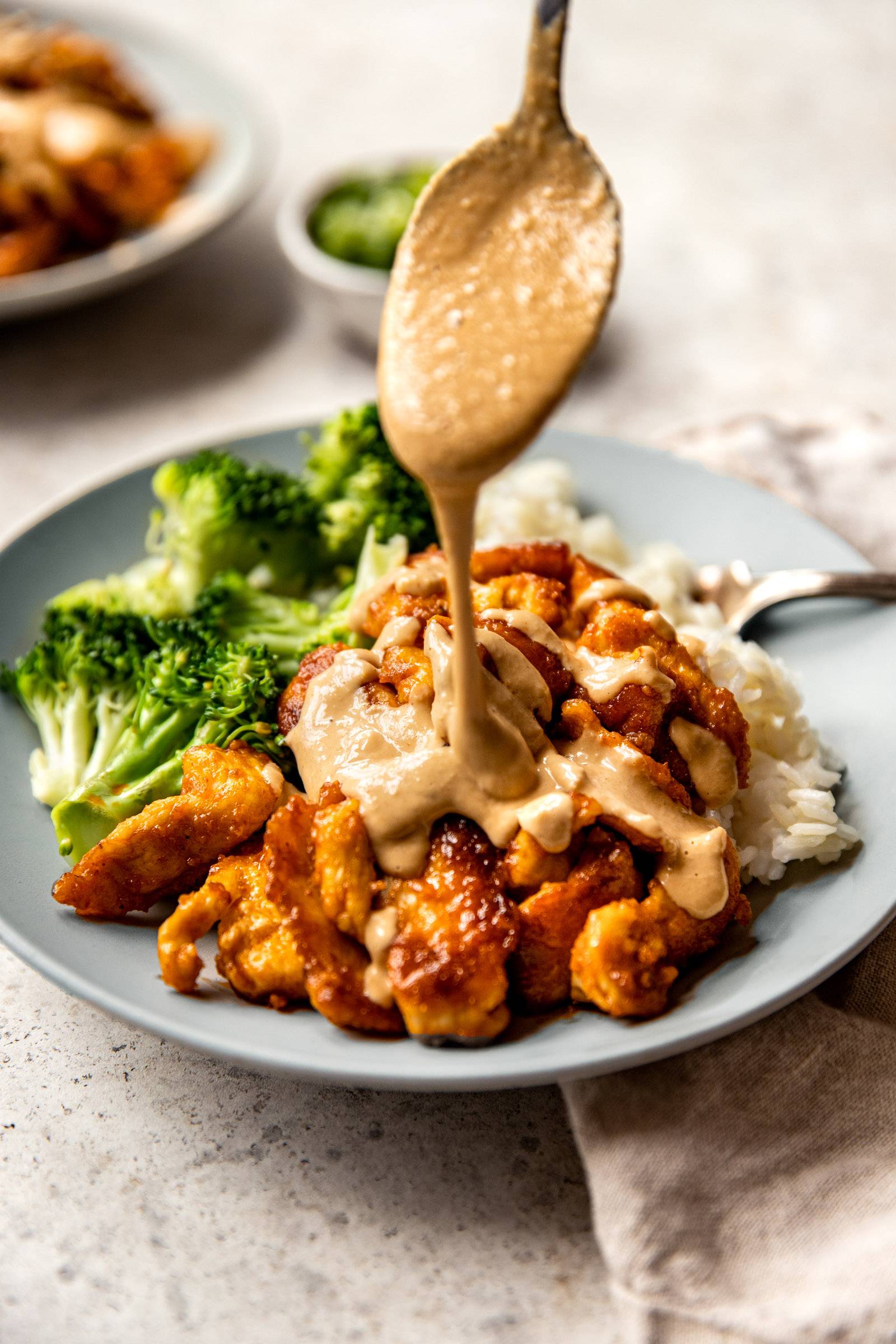 Cashew sauce drizzled over red curry chicken stir-fry
