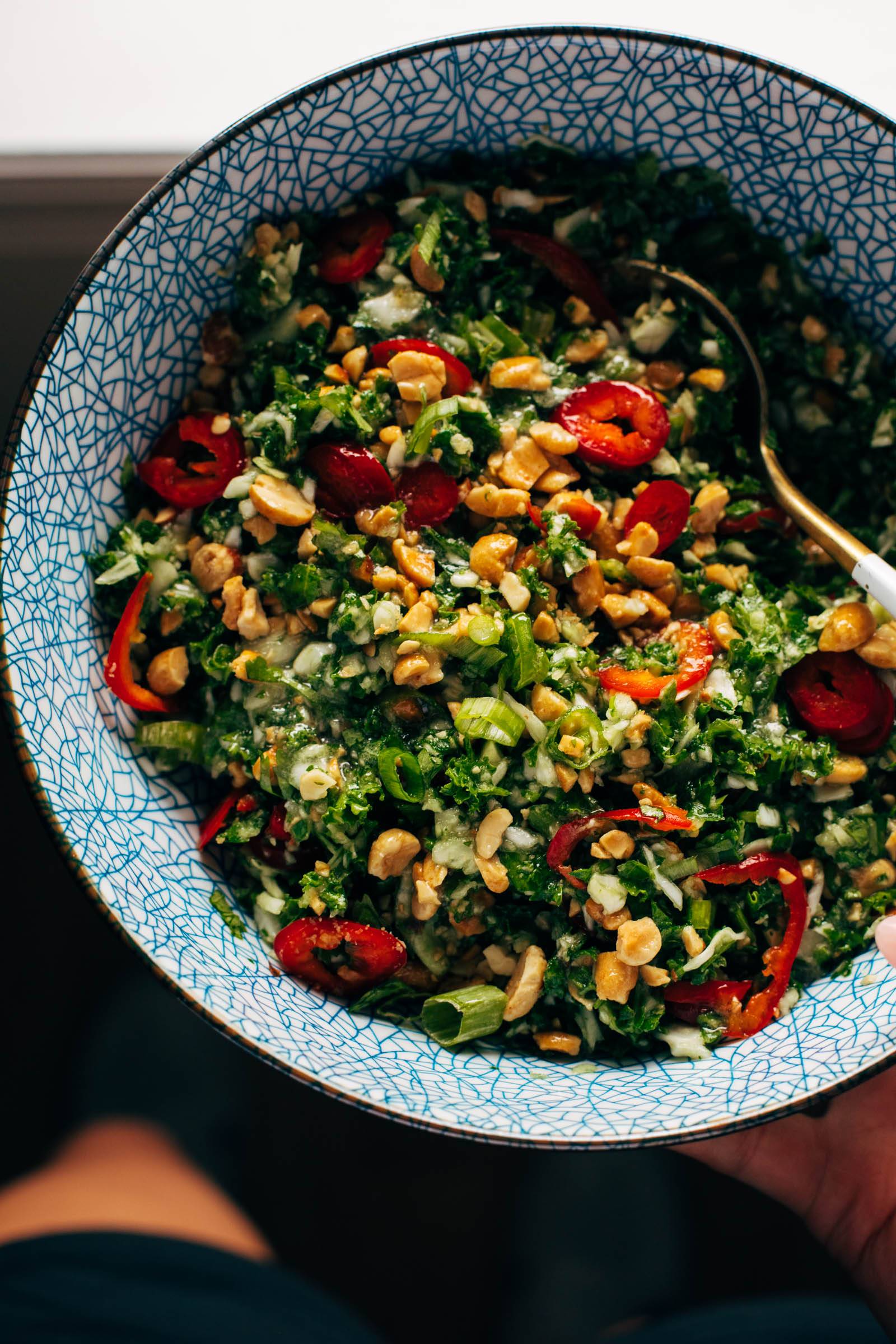 Roasted peanut kale crunch salad in a blue bowl