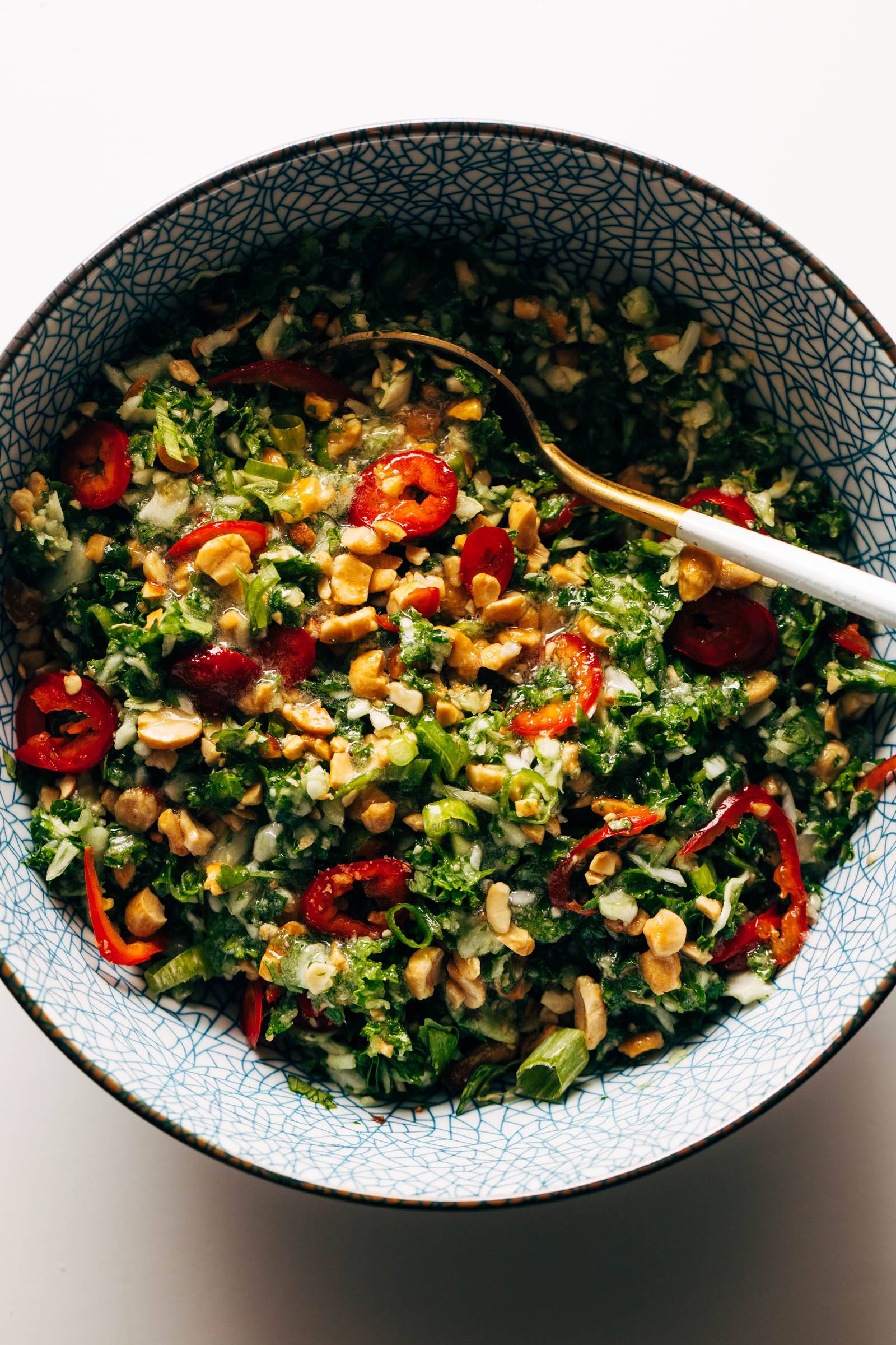 Peanut kale salad in a bowl with a spoon
