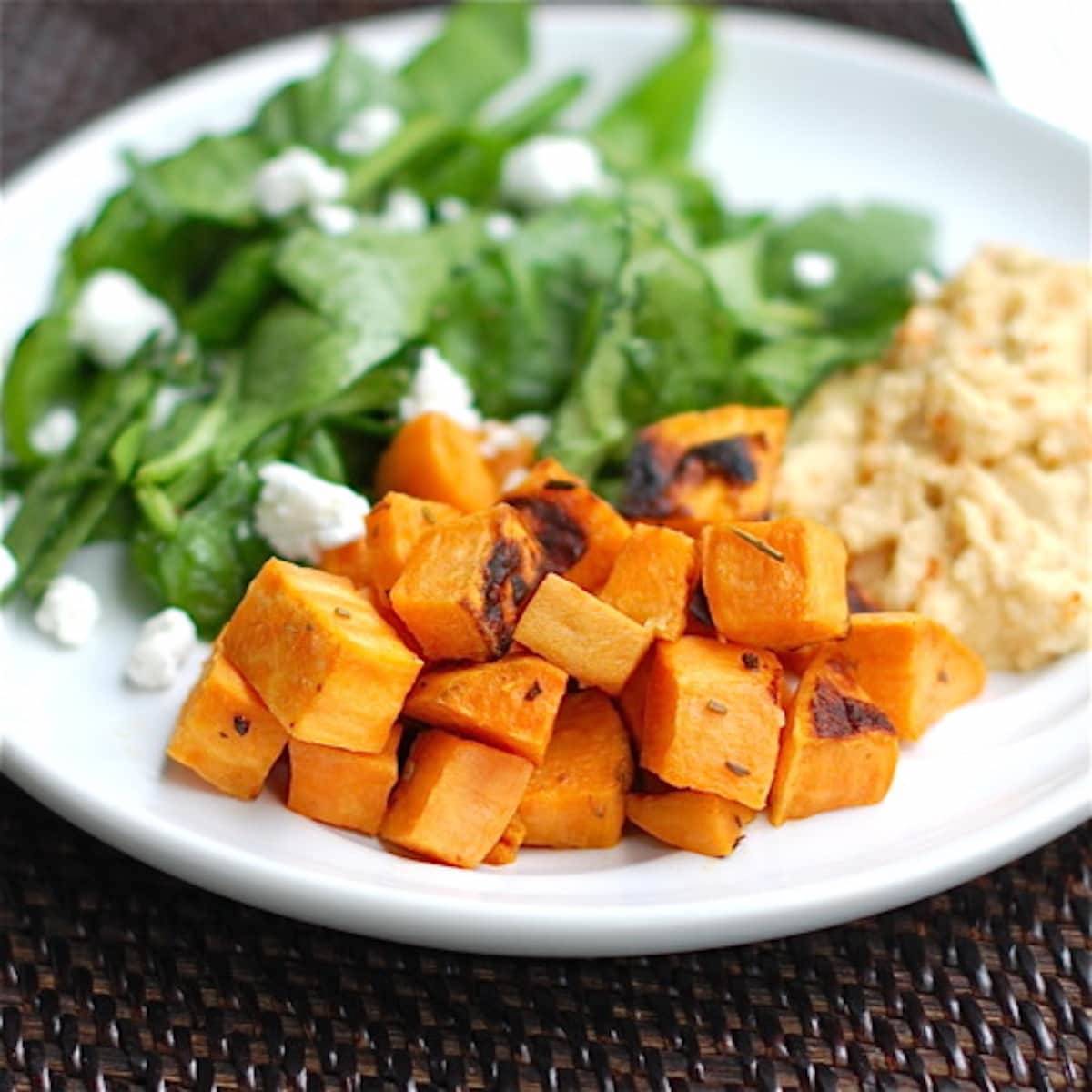 Roasted sweet potatoes  with a side of hummus and a spinach salad. 