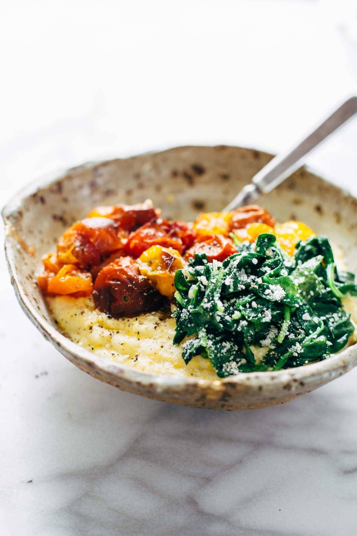Roasted Tomatoes with Goat Cheese Polenta! Fresh, juicy tomatoes, vibrant green spinach, and a creamy goat cheese polenta! | pinchofyum.com