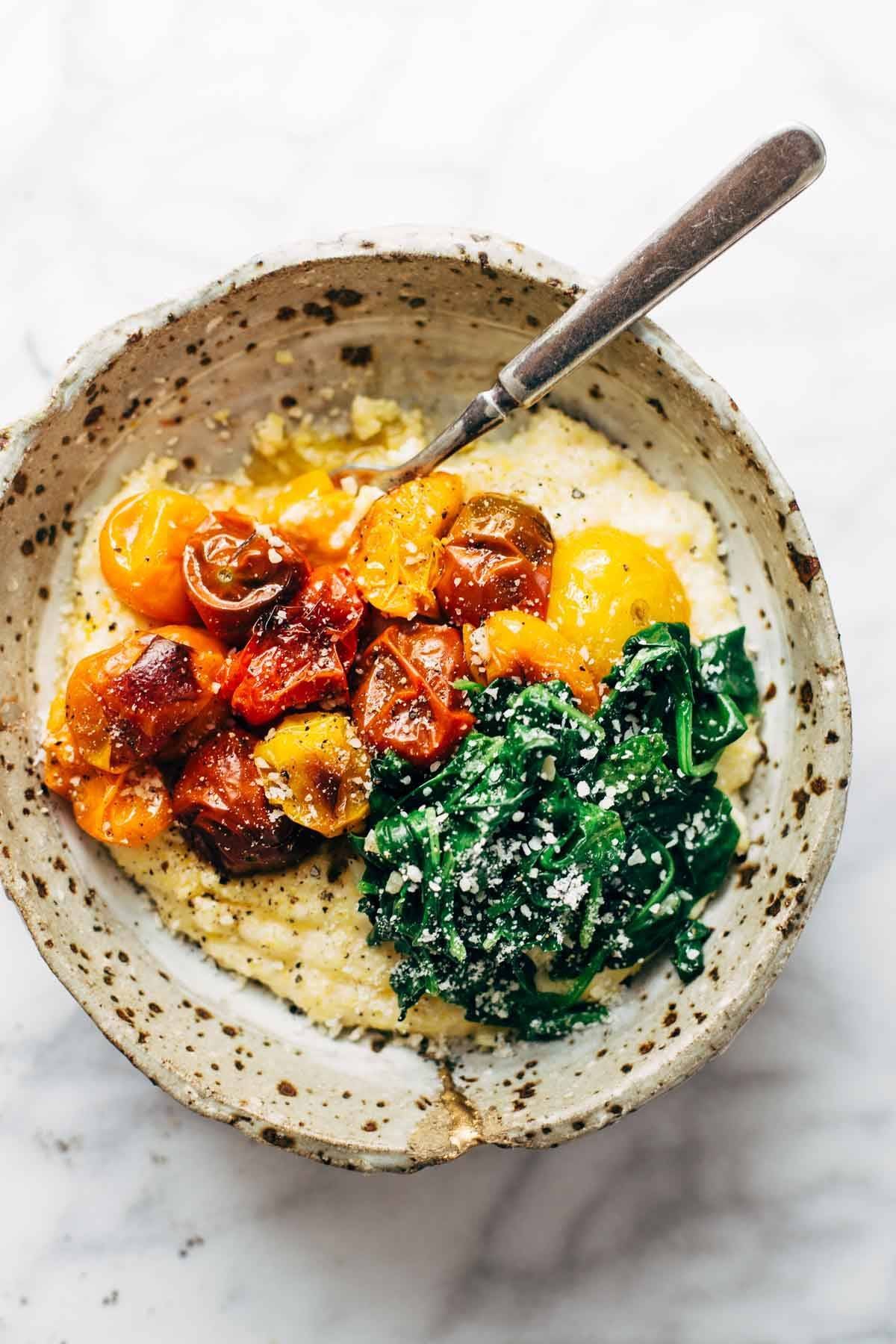 Roasted Tomatoes with Goat Cheese Polenta! Fresh, juicy tomatoes, vibrant green spinach, and a creamy goat cheese polenta! | pinchofyum.com