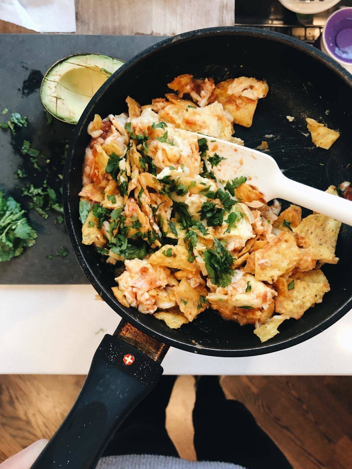 Migas in a frying pan with a spatula.