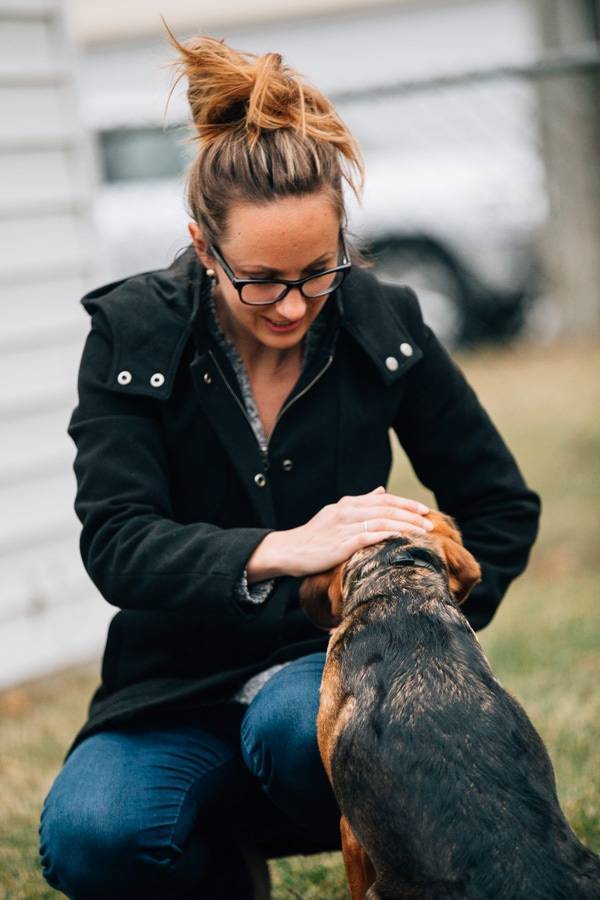 Woman petting a dog.