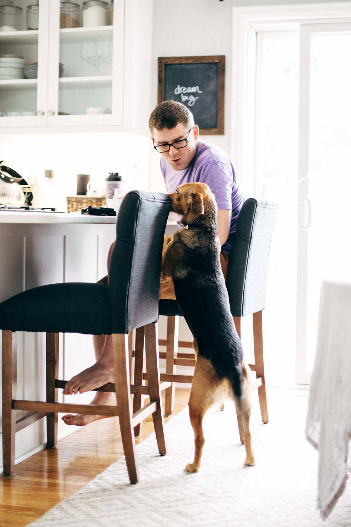 Man and dog in a kitchen.