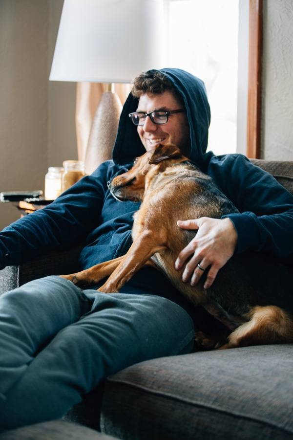 Dog and man cuddling.