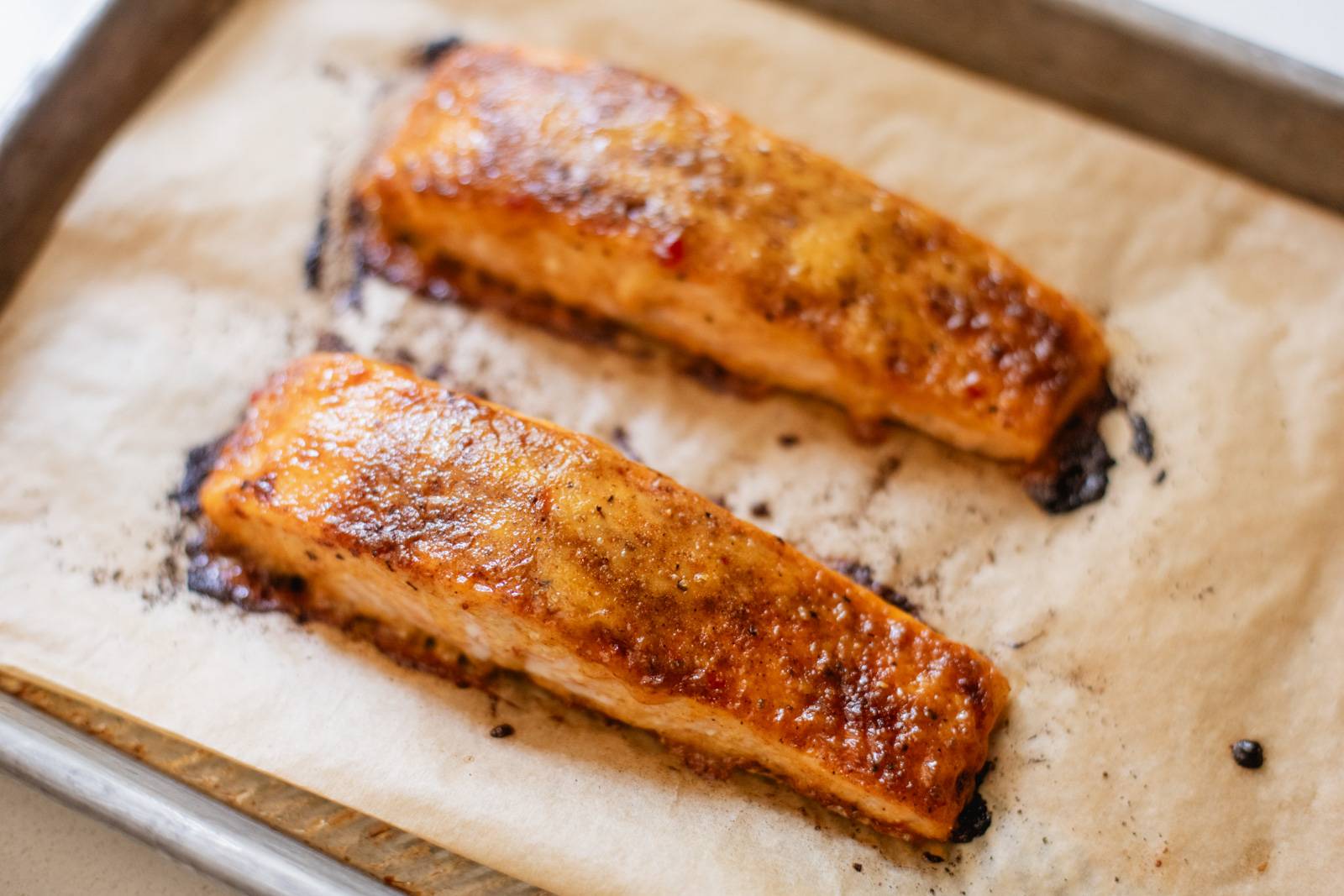 Baked browned salmon on a sheet pan.