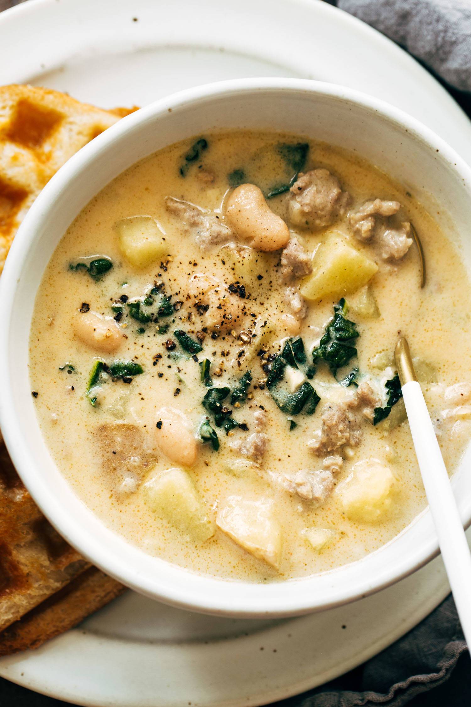 Sausage and white bean soup in a bowl.