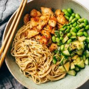 Sauteed chicken, edamame and cucumber over a bed of spaghetti.