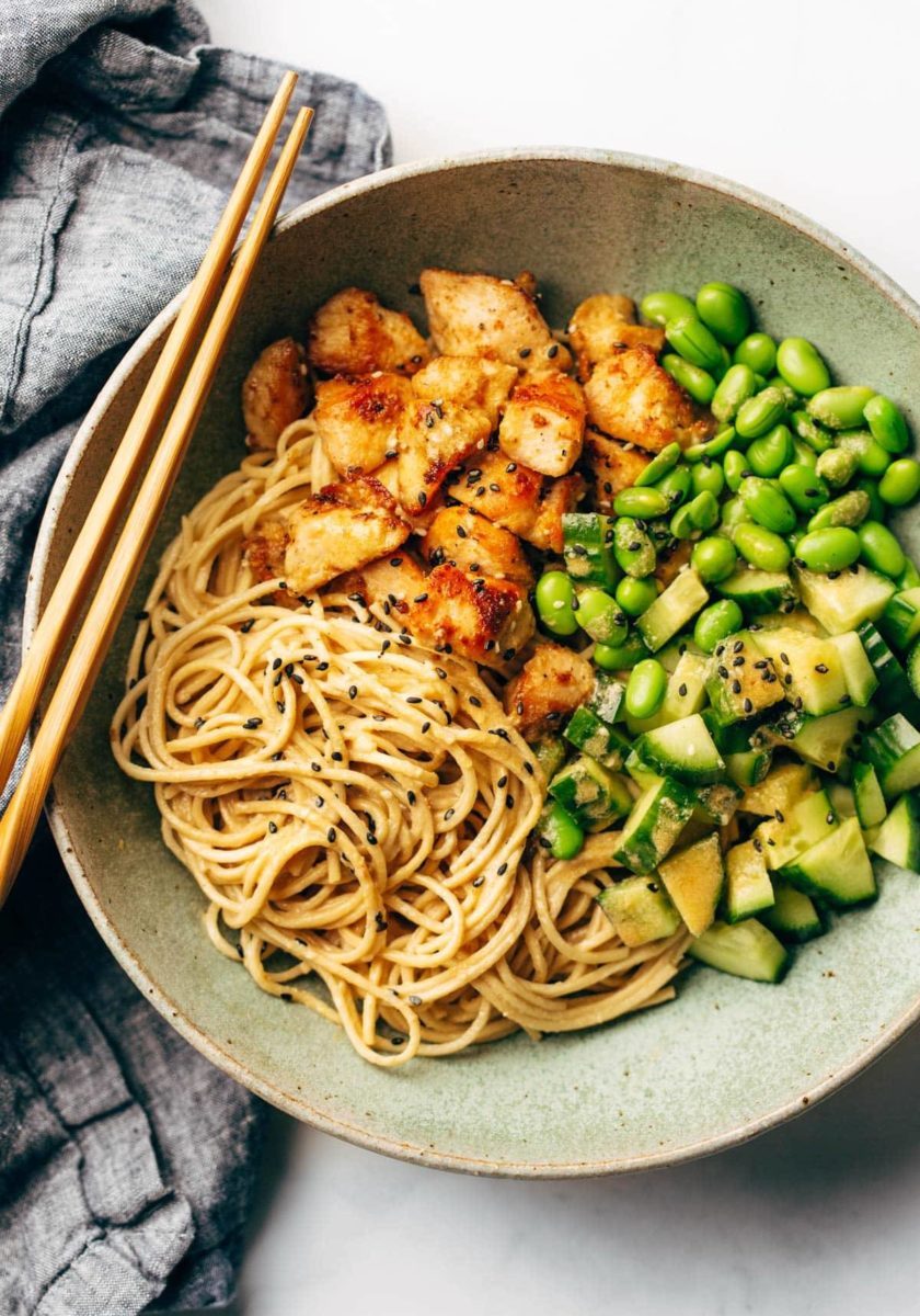 Sauteed chicken, edamame and cucumber over a bed of spaghetti.