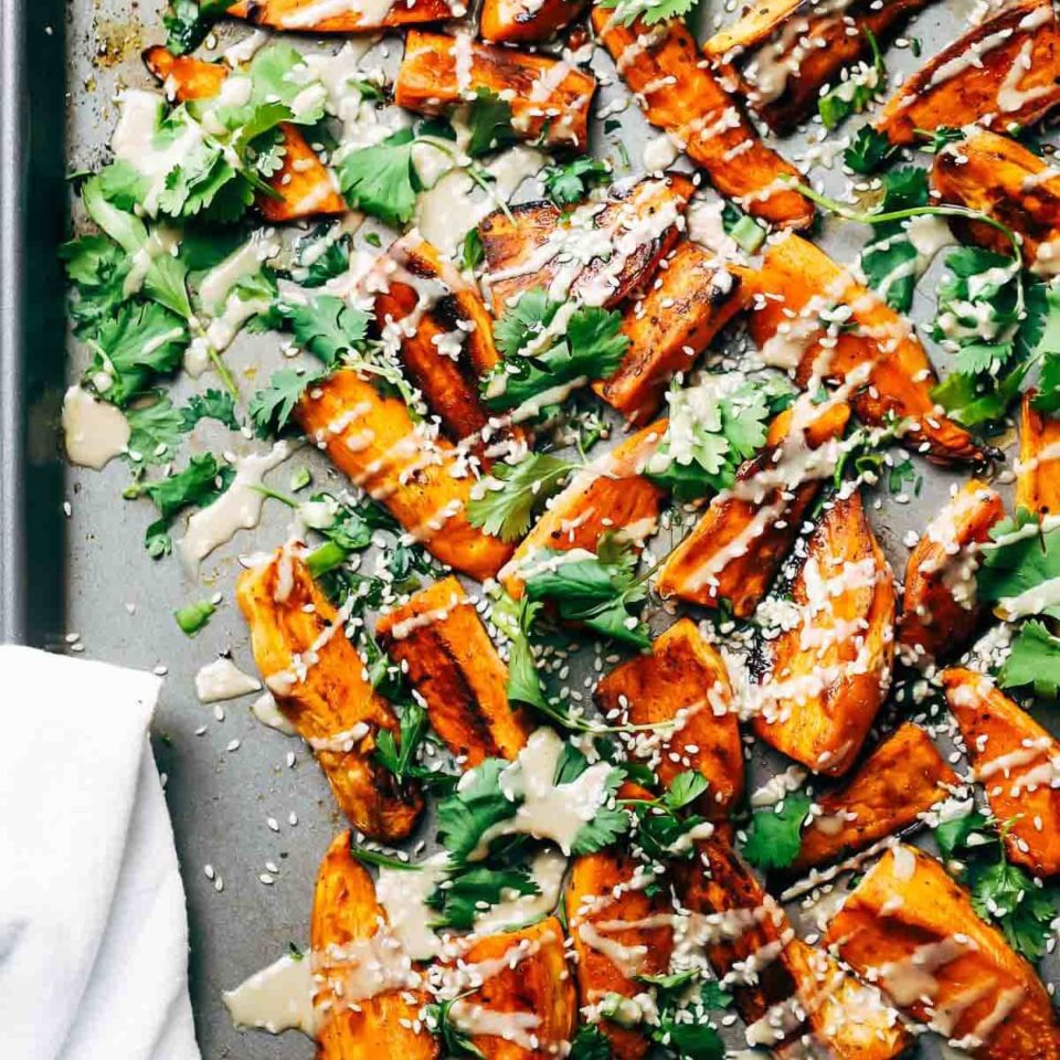 Sesame Roasted Sweet Potatoes baked on a sheet pan.