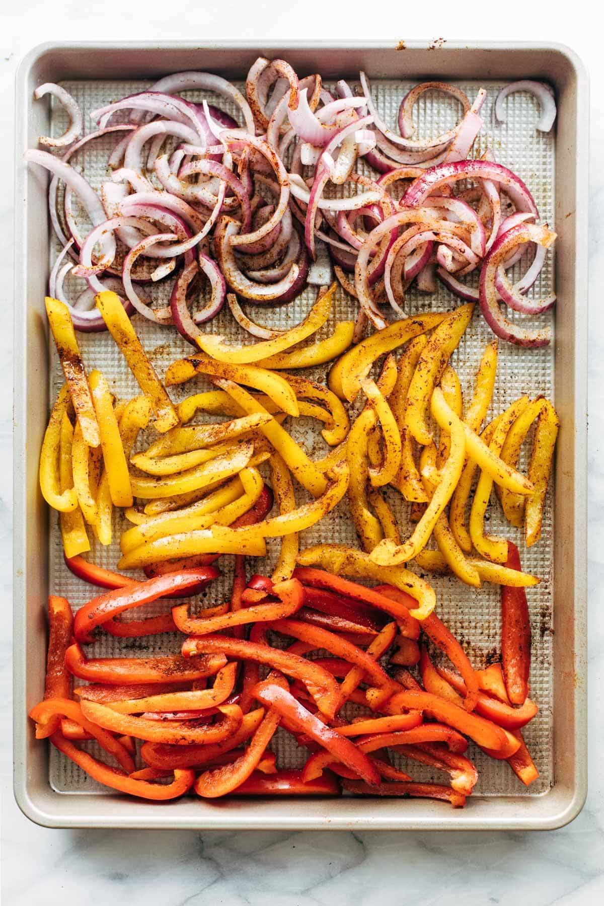 Onions and peppers on a sheet pan.