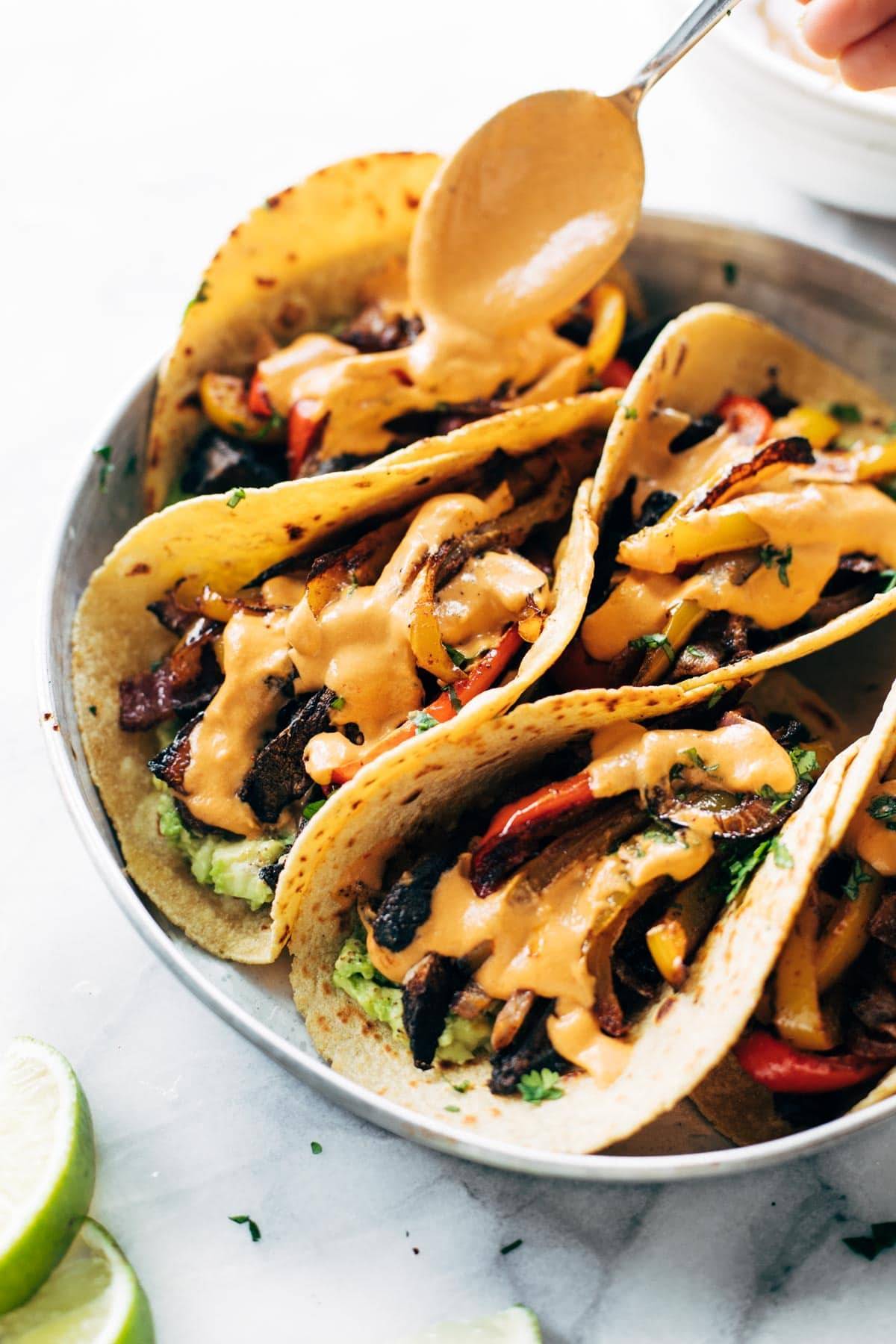 A plate of fajitas and with queso.