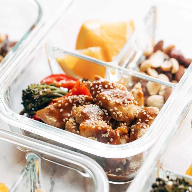 Sheet Pan Garlic Ginger Chicken and Broccoli in a clear container.