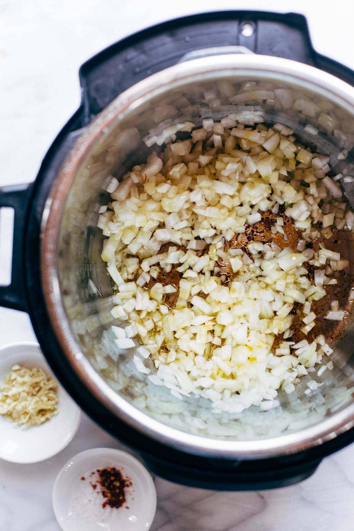 Onions and garlic in an Instant Pot.