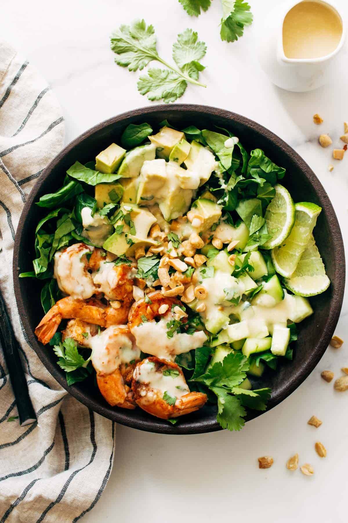 Shrimp and Avocado Salad with Miso Dressing in a Bowl. 