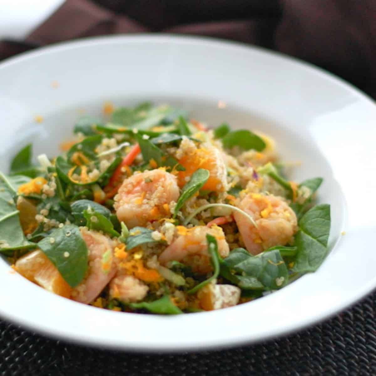 Shrimp and quinoa salad in a white bowl.